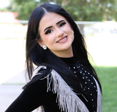 Smiling woman with blonde hair, wearing hoop earrings.