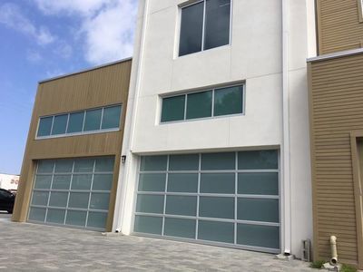 A large building with a lot of windows and a lot of garage doors.
