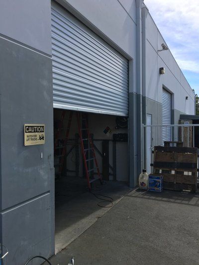 A sign on the side of a building says caution