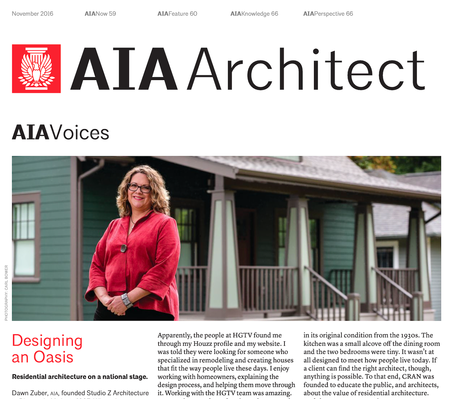 A woman in a red shirt is standing in front of a house.