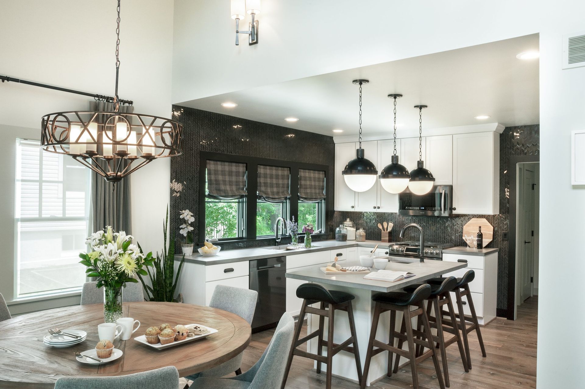 A kitchen with a table and chairs and a chandelier hanging from the ceiling.