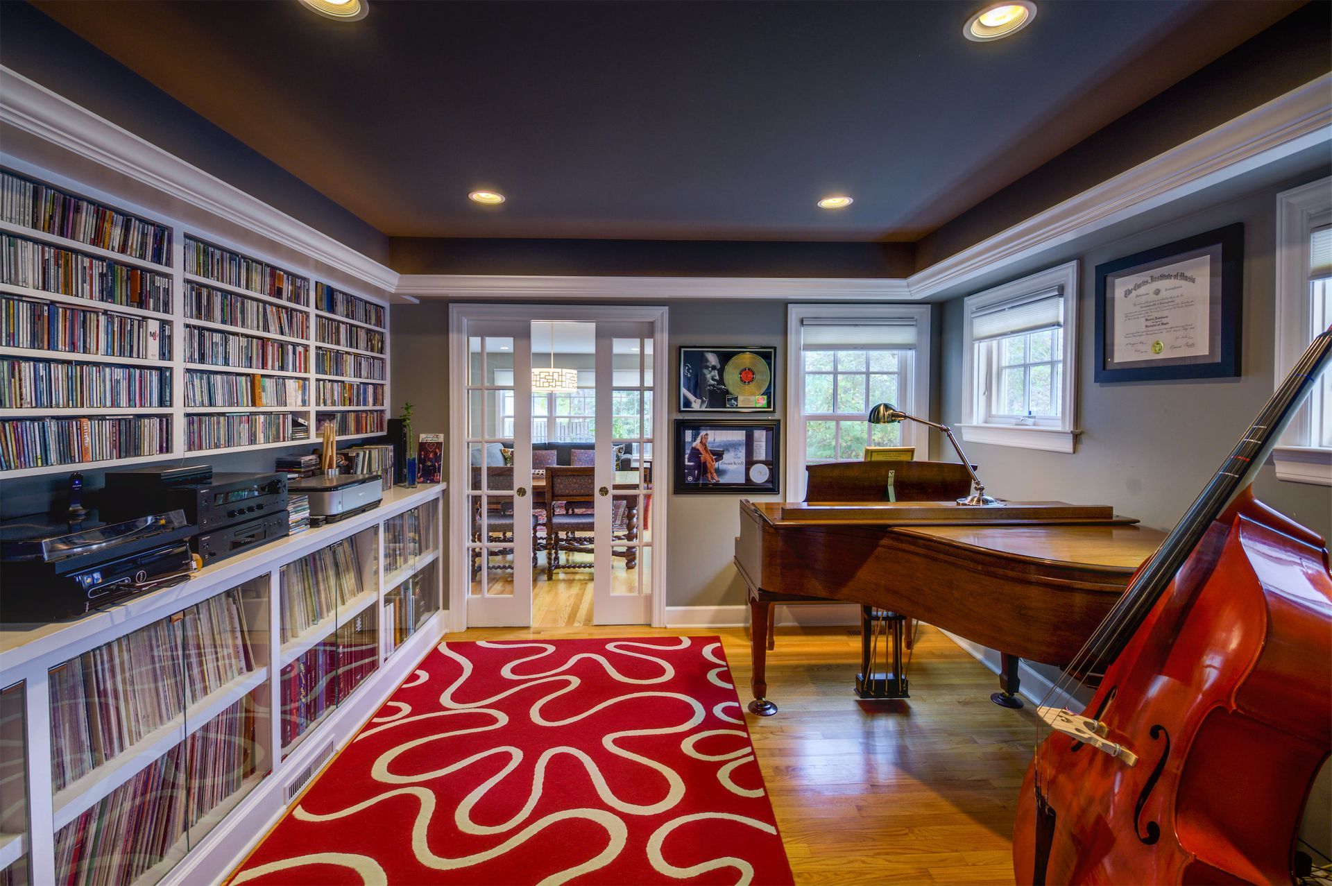 A room with a piano and a cello in it