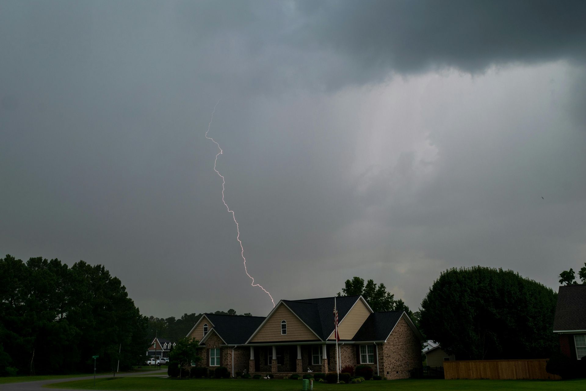 A lightning bolt strikes a house during a storm