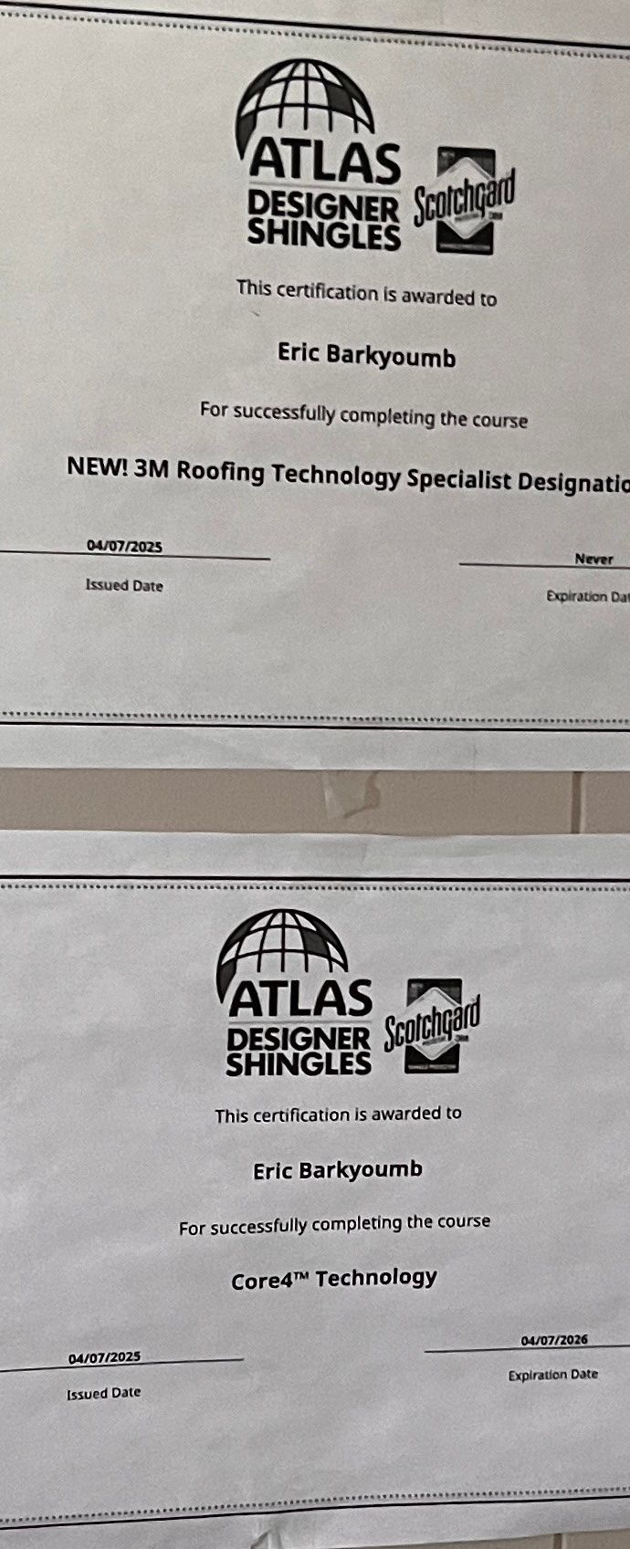 Blurry photo of two Atlas Shingles document pages stacked vertically on a light background Blurry photo of two Atlas Shingles document pages stacked vertically on a light background