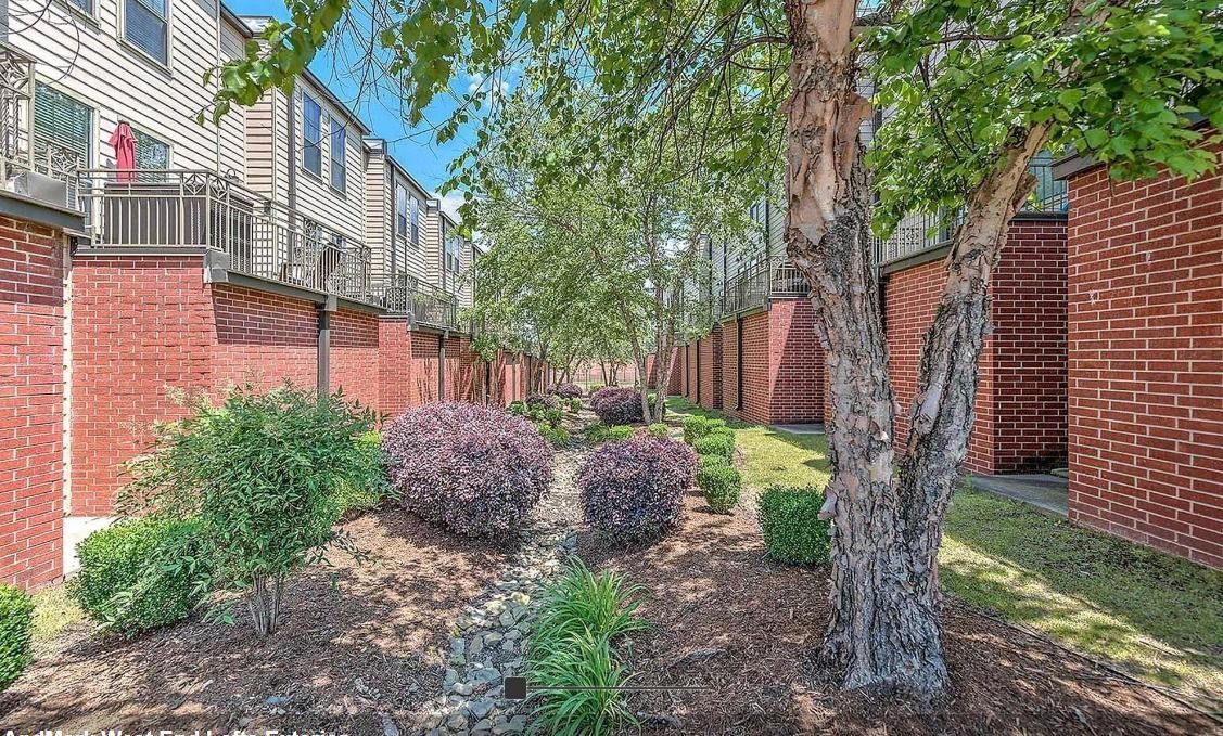A brick building with a lot of trees in front of it.
