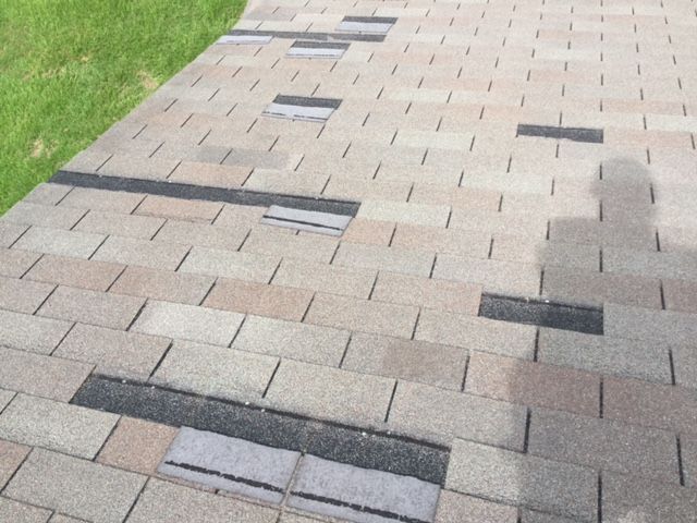 A brick walkway with a shadow of a person on it