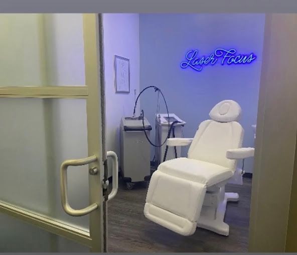 A room with a chair and a sign that says laser focus