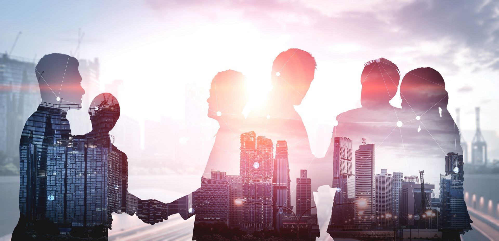 Business people shaking hands, overlaid on a cityscape. Teamwork, collaboration at Stellar MLS. 