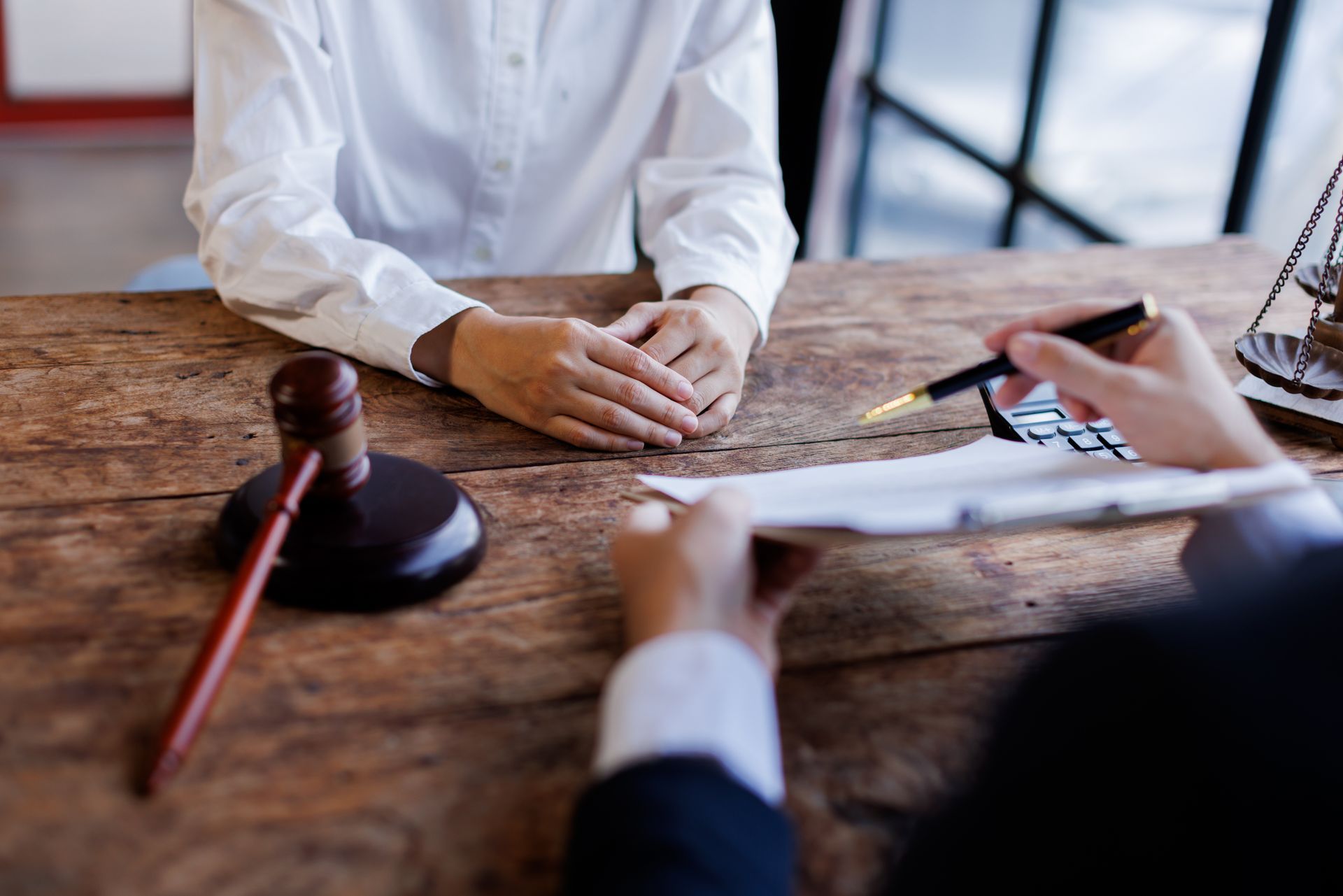 An attorney is speaking with a client. An attorney is speaking with a client.