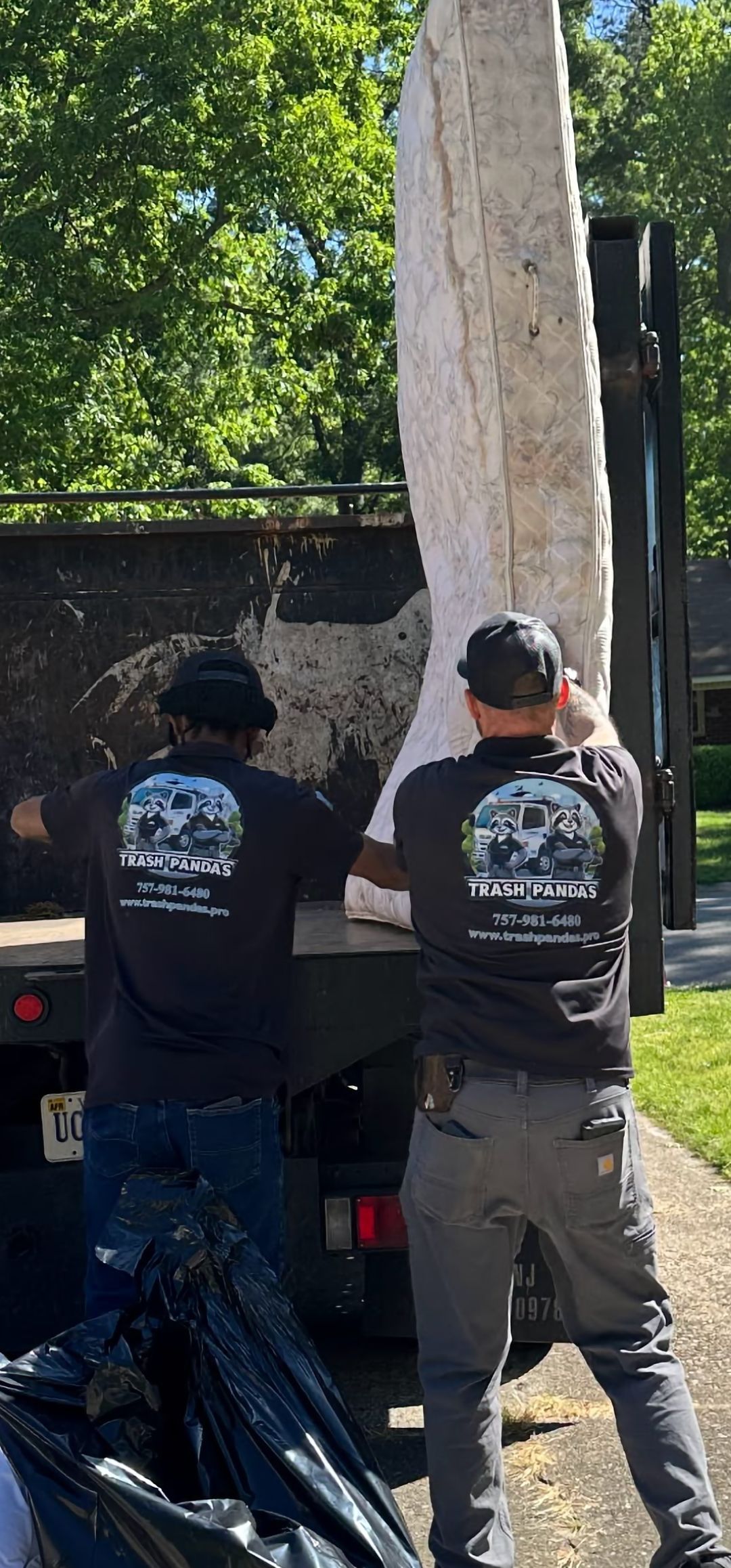 A man is carrying a bag of rubble on a cart.