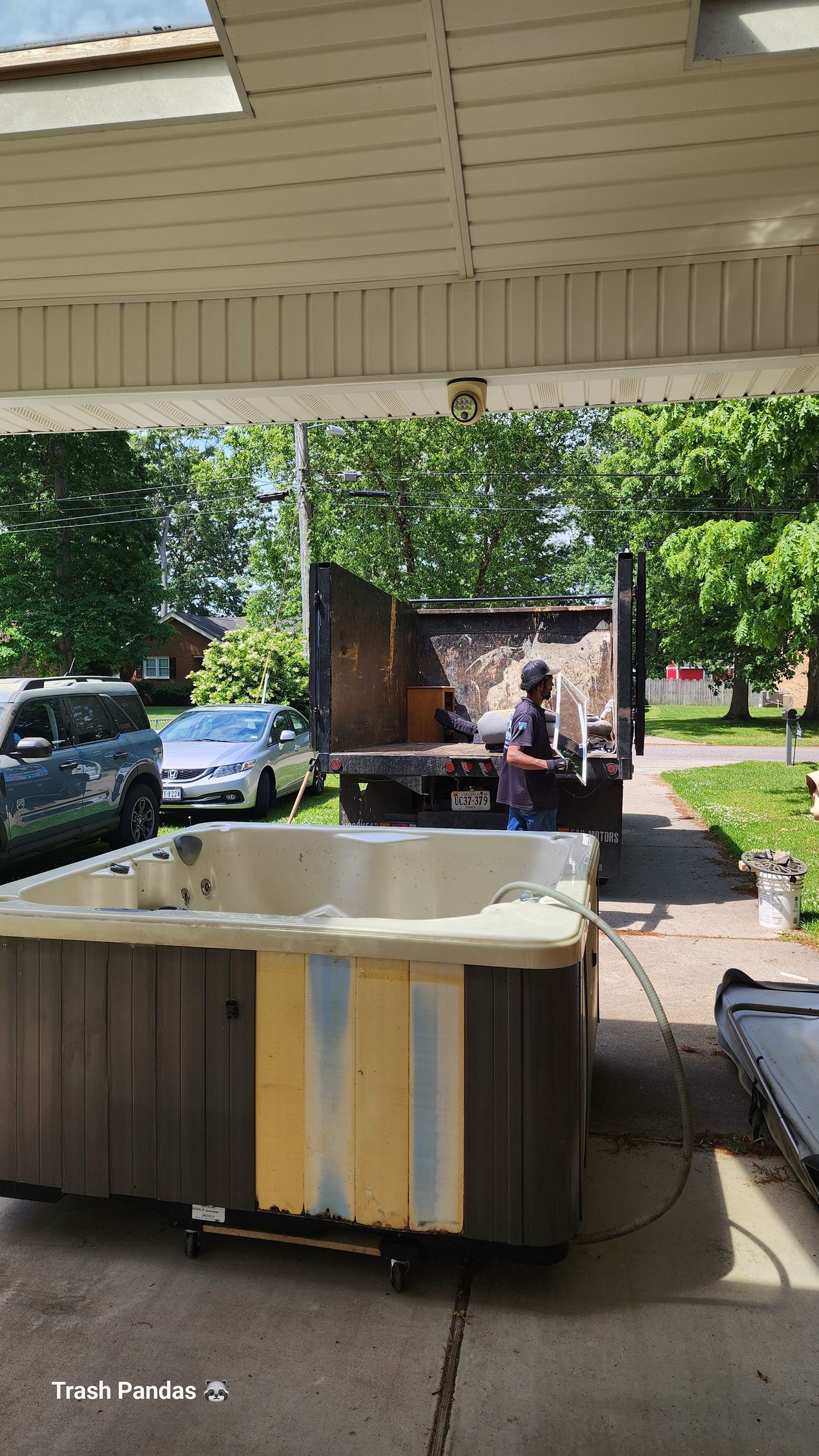 A white bathtub is sitting on a wooden floor in a bathroom.