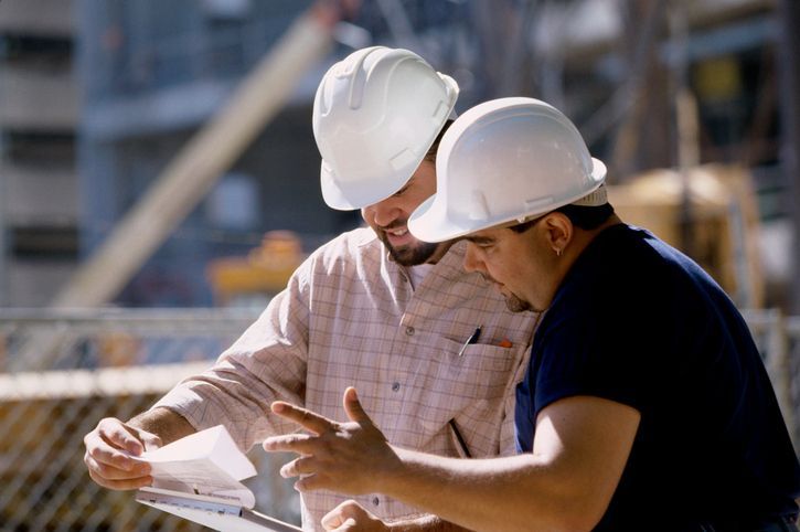 A feather pen is sitting on top of a stack of books