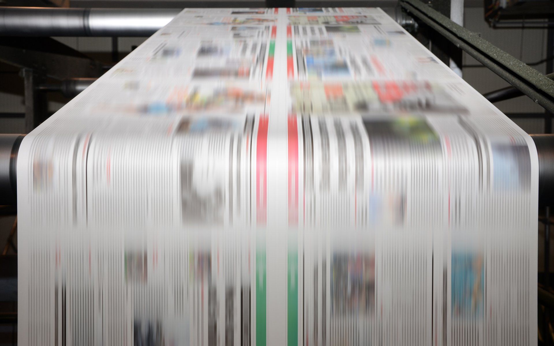 Newspaper rushing by on a printing press