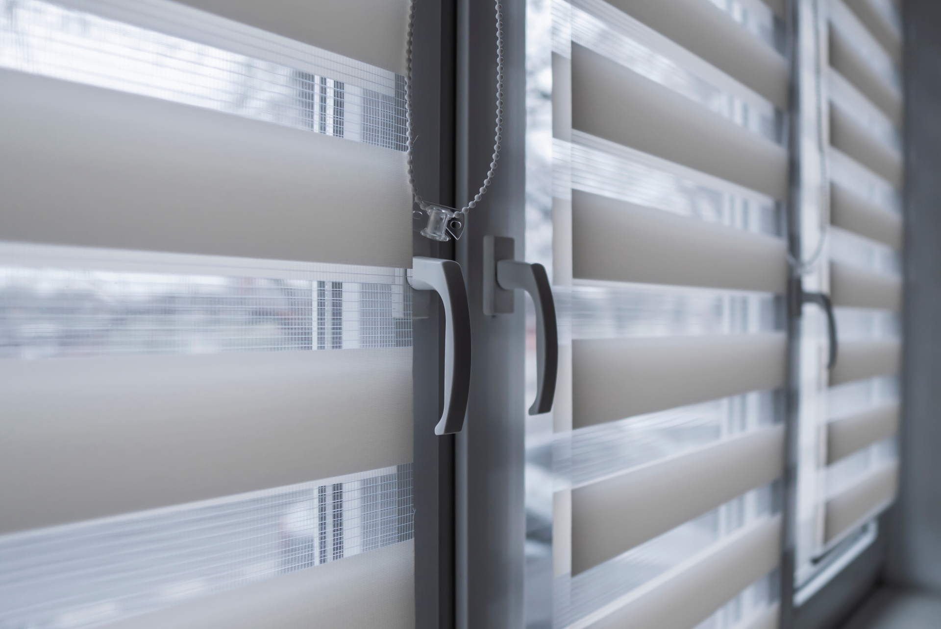 A close up of a window with blinds on it.