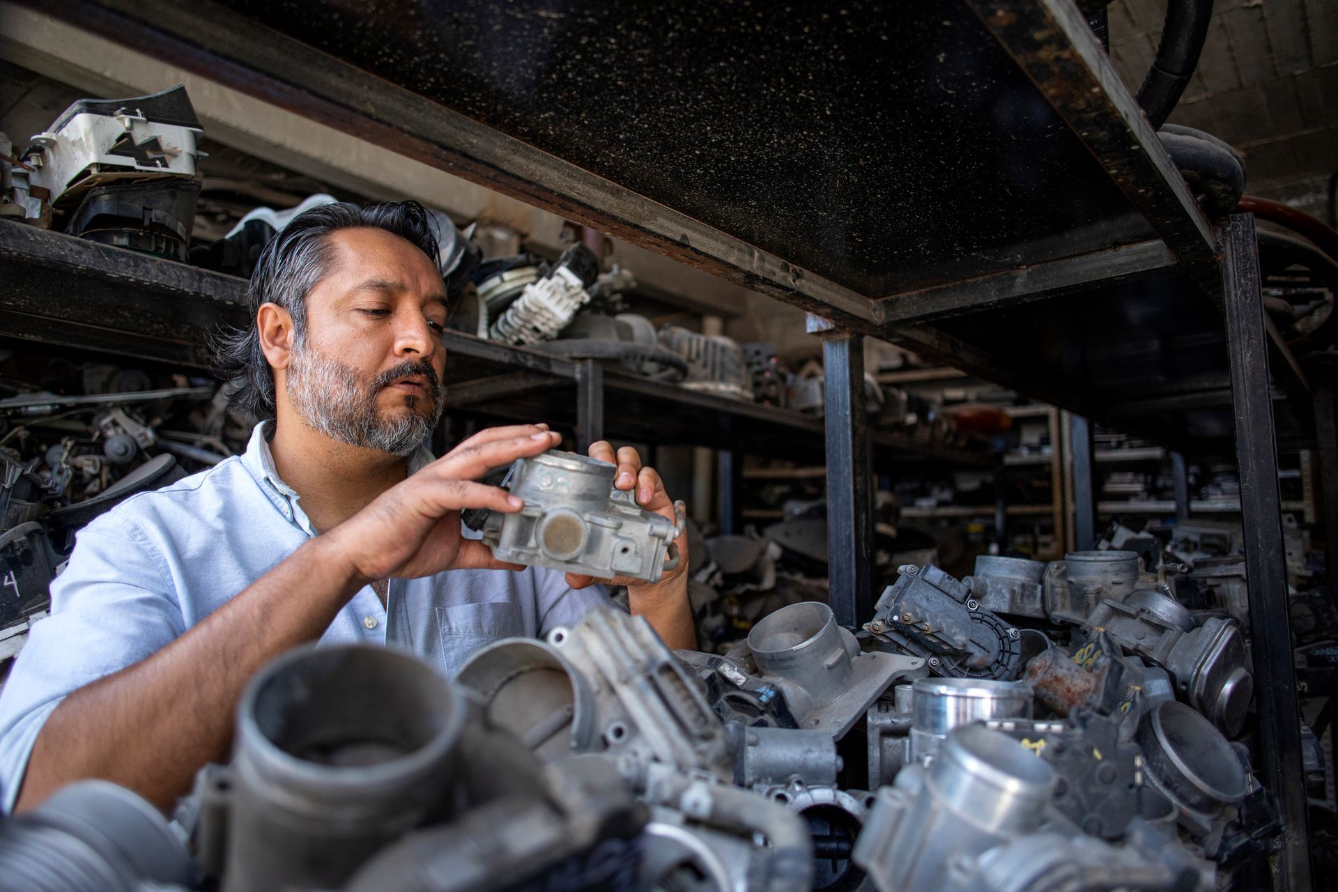 Man working in a used auto parts business