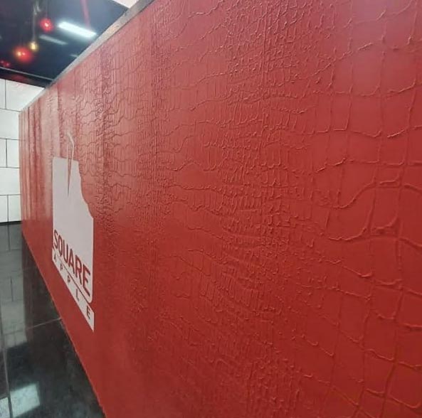 Red wall with textured plaster and white shop logo