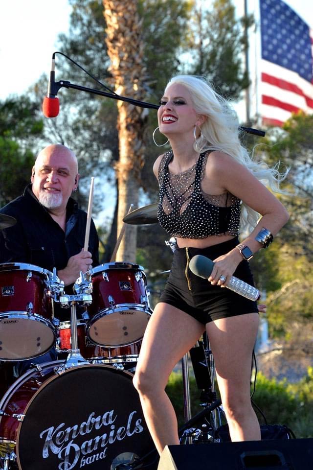 woman and drummer performing