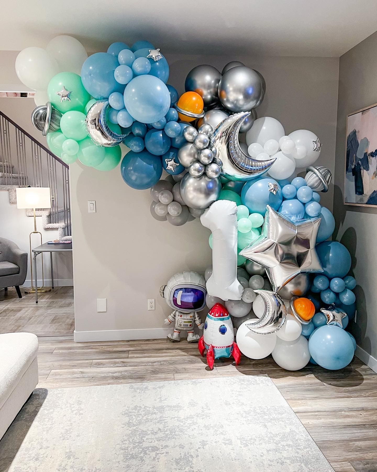 A living room filled with balloons and a rocket.