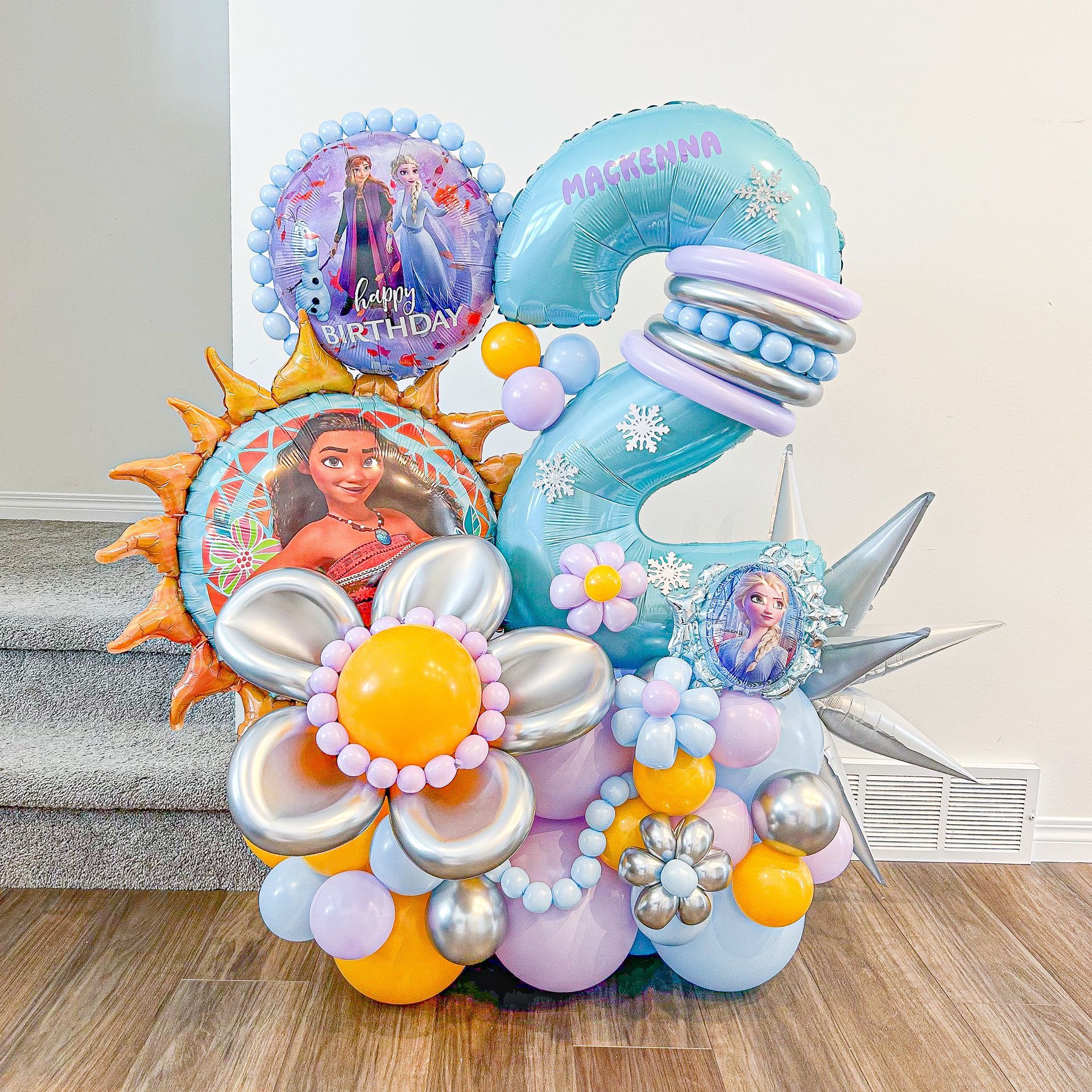 A bunch of balloons are sitting on a wooden floor.