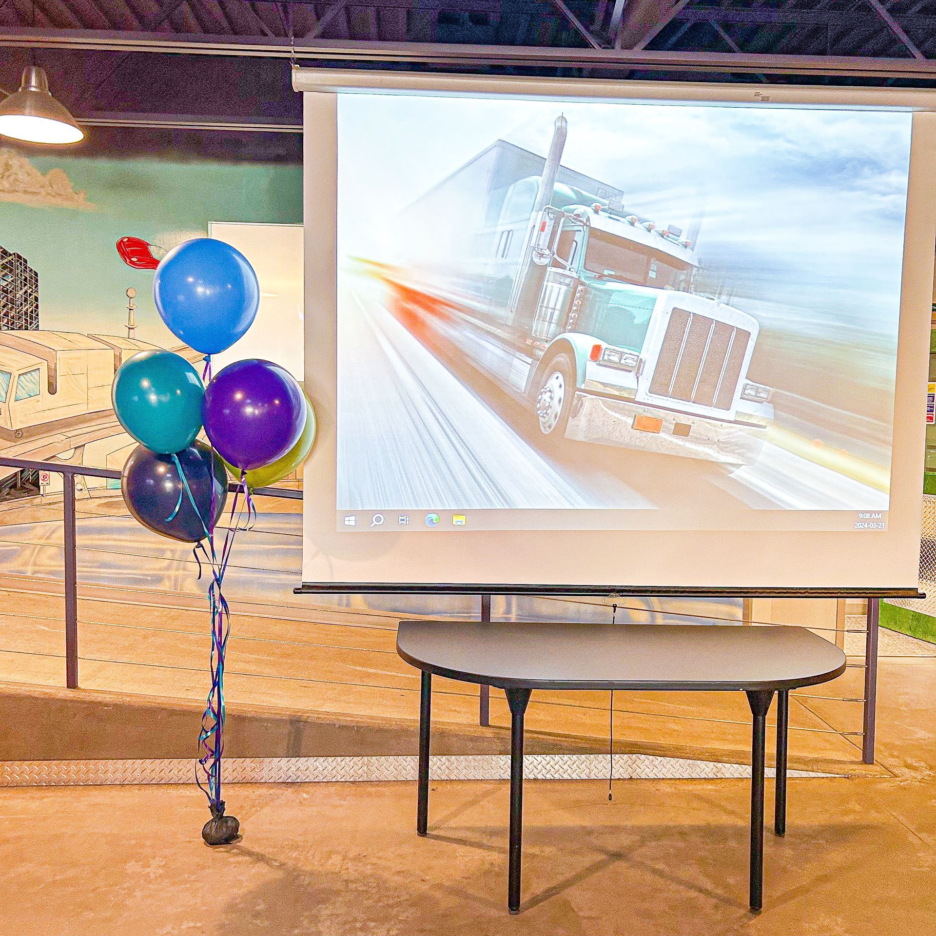 A projector screen with a picture of a truck on it