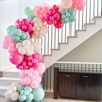 A bunch of balloons are sitting on top of a staircase.