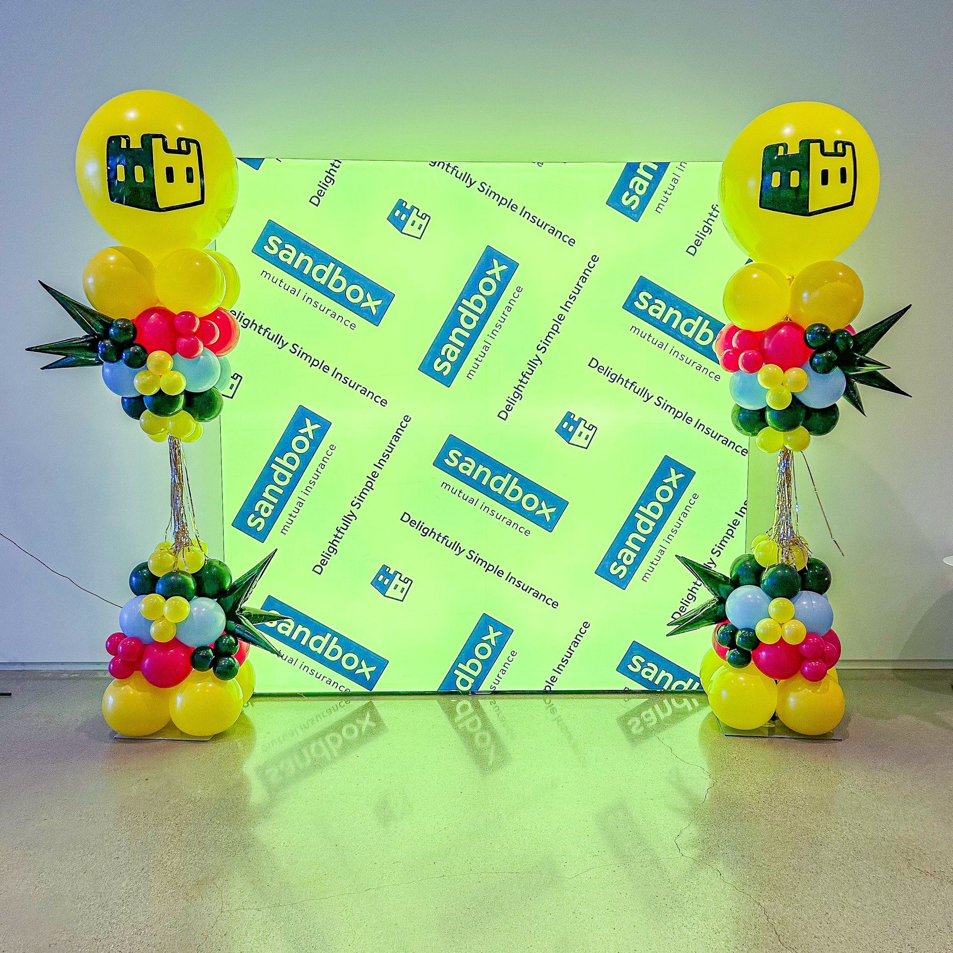 A room decorated with blue and white balloons and silver balloons.