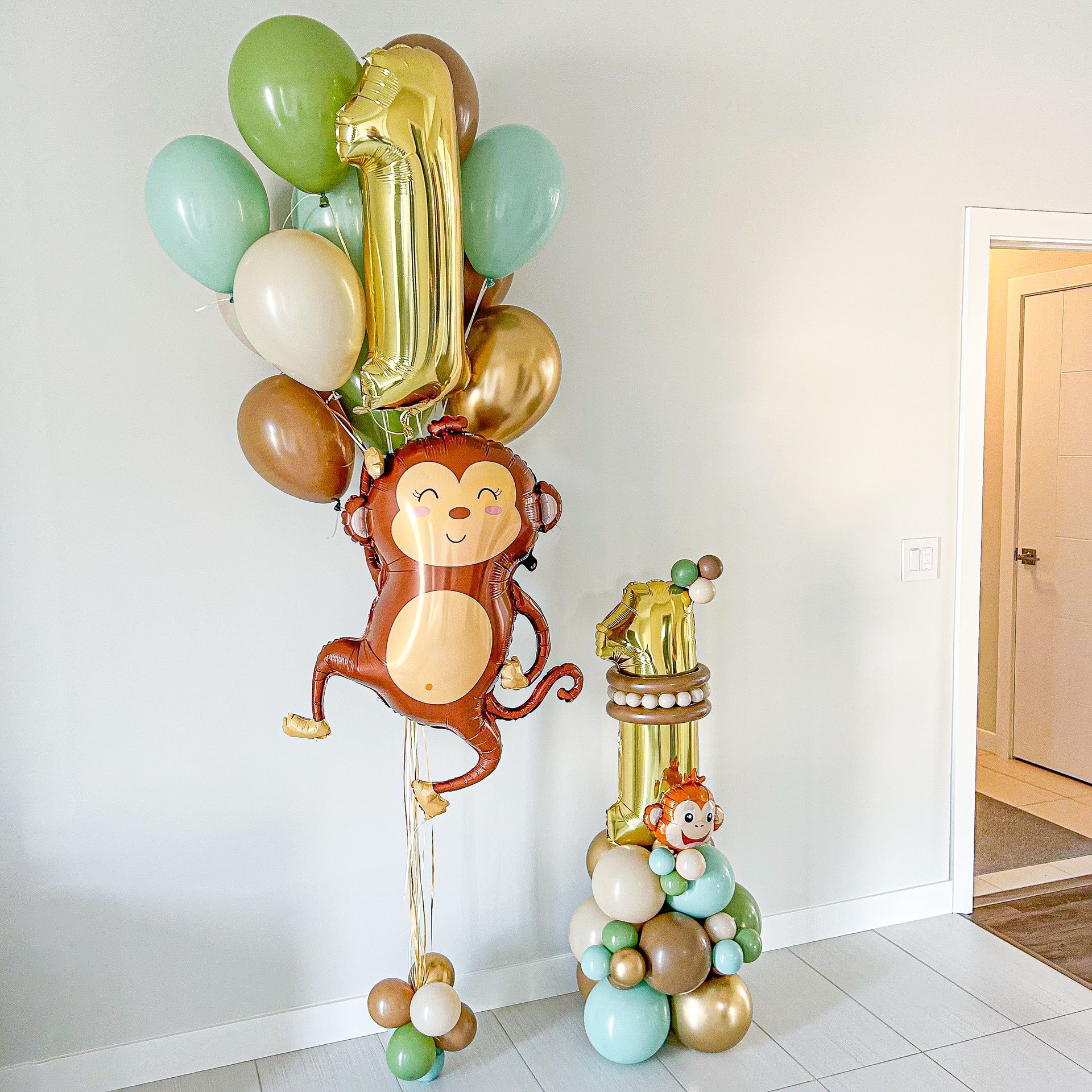 A bunch of balloons with a monkey on top of them