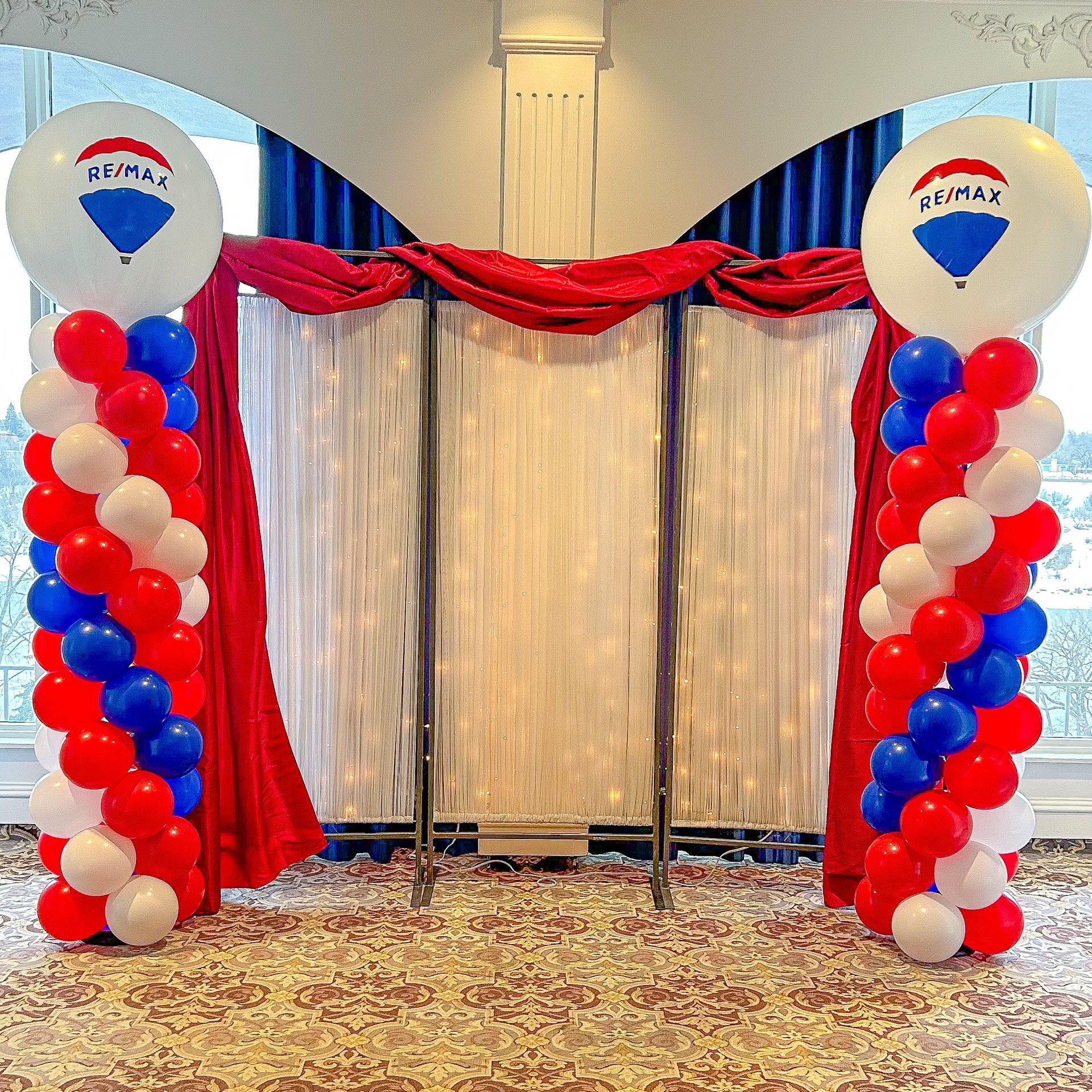 A room with purple and white balloons and a purple quilt