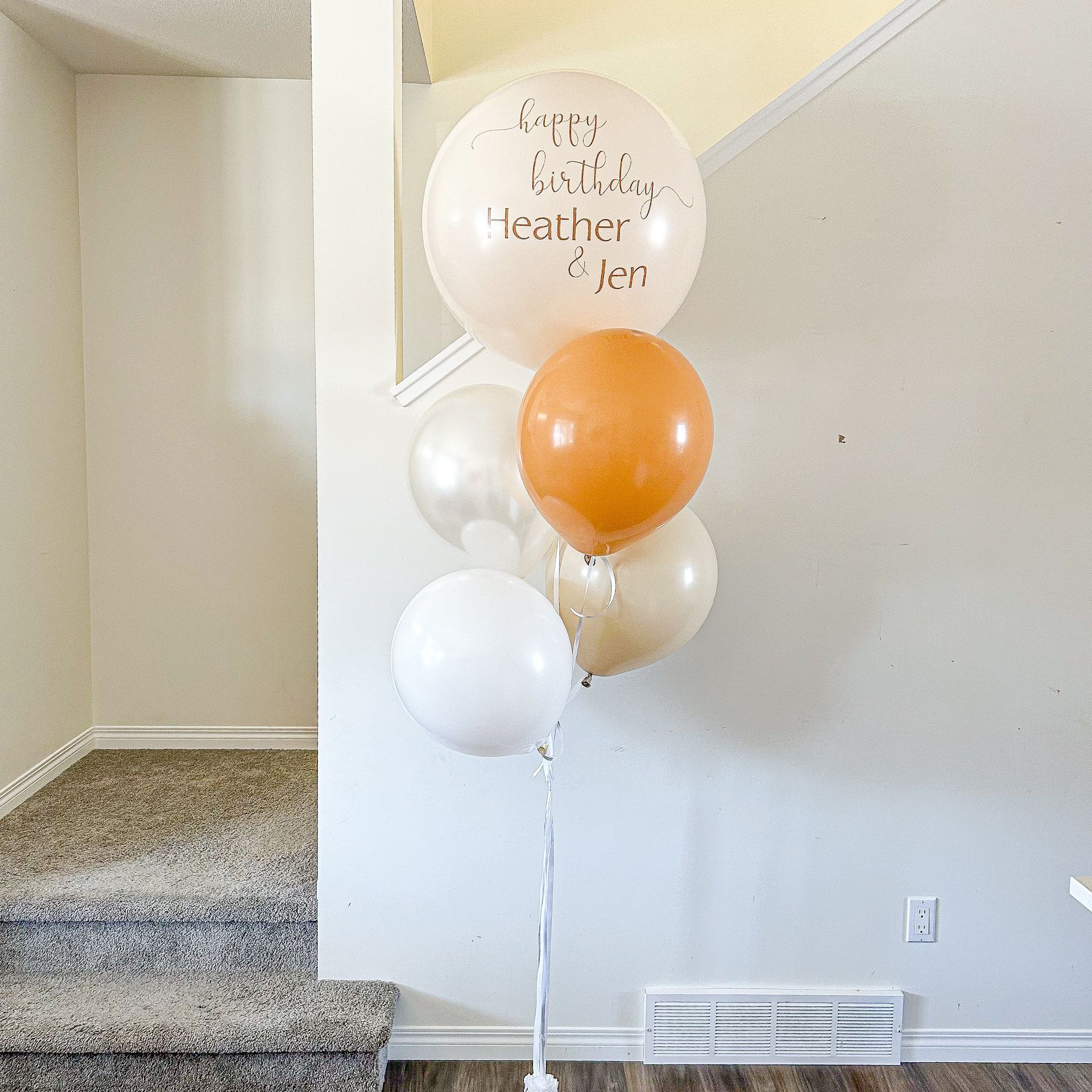 A bunch of balloons with one that says happy birthday heather