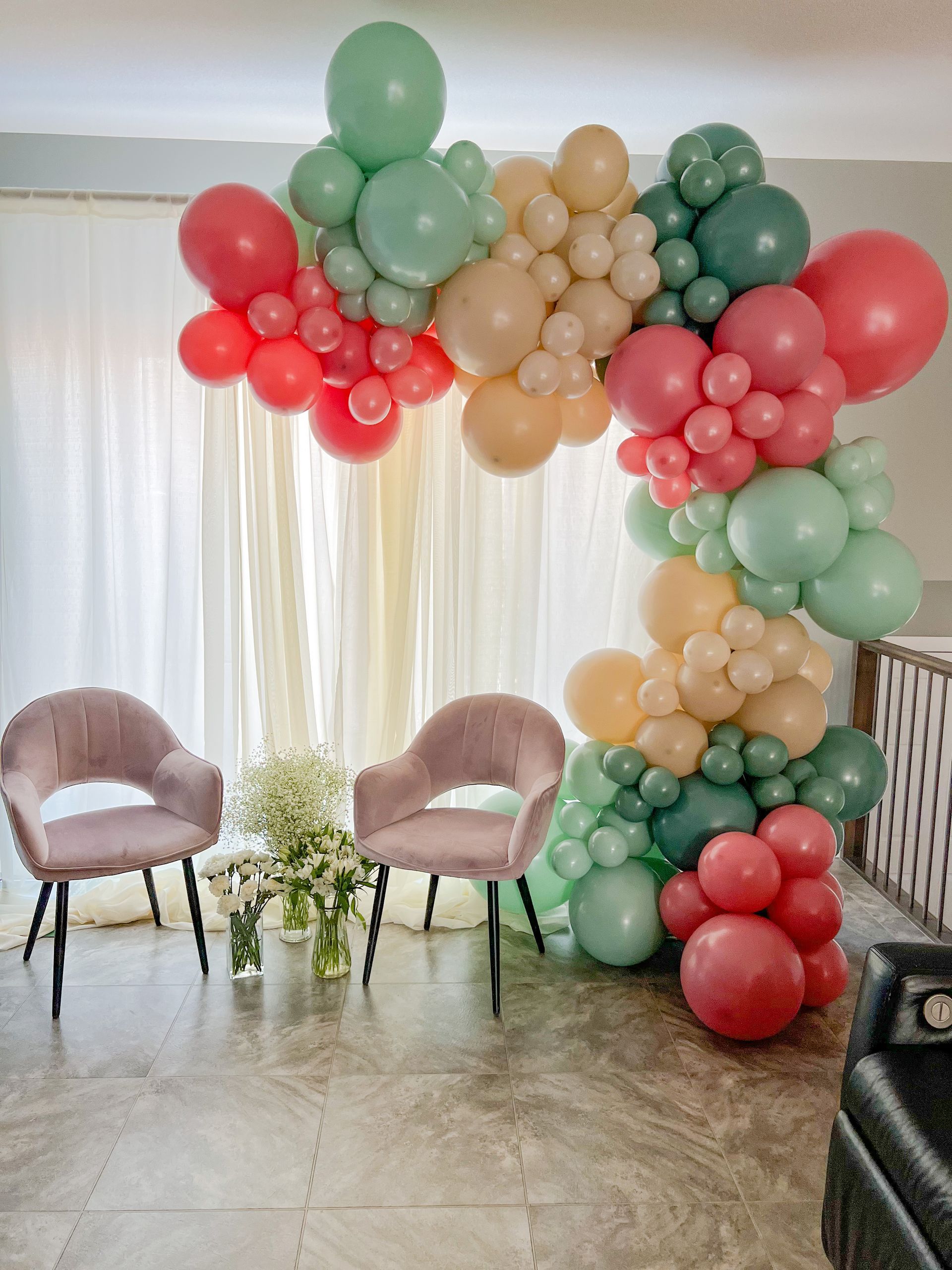 A room filled with lots of balloons and chairs.