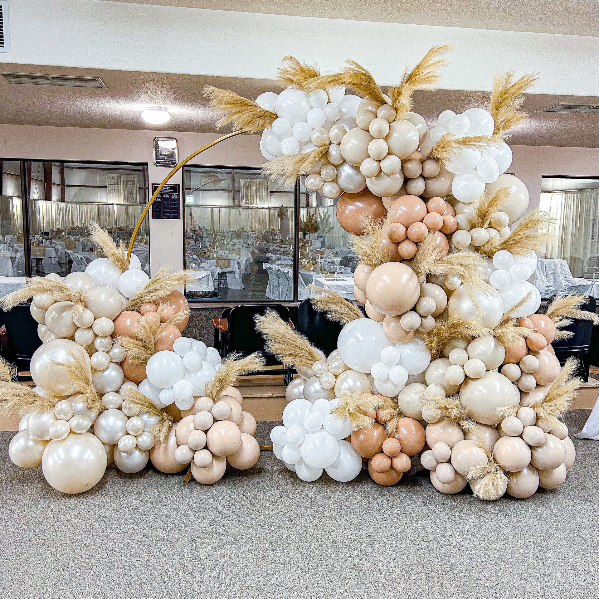 A bunch of balloons are sitting on the floor in a room.