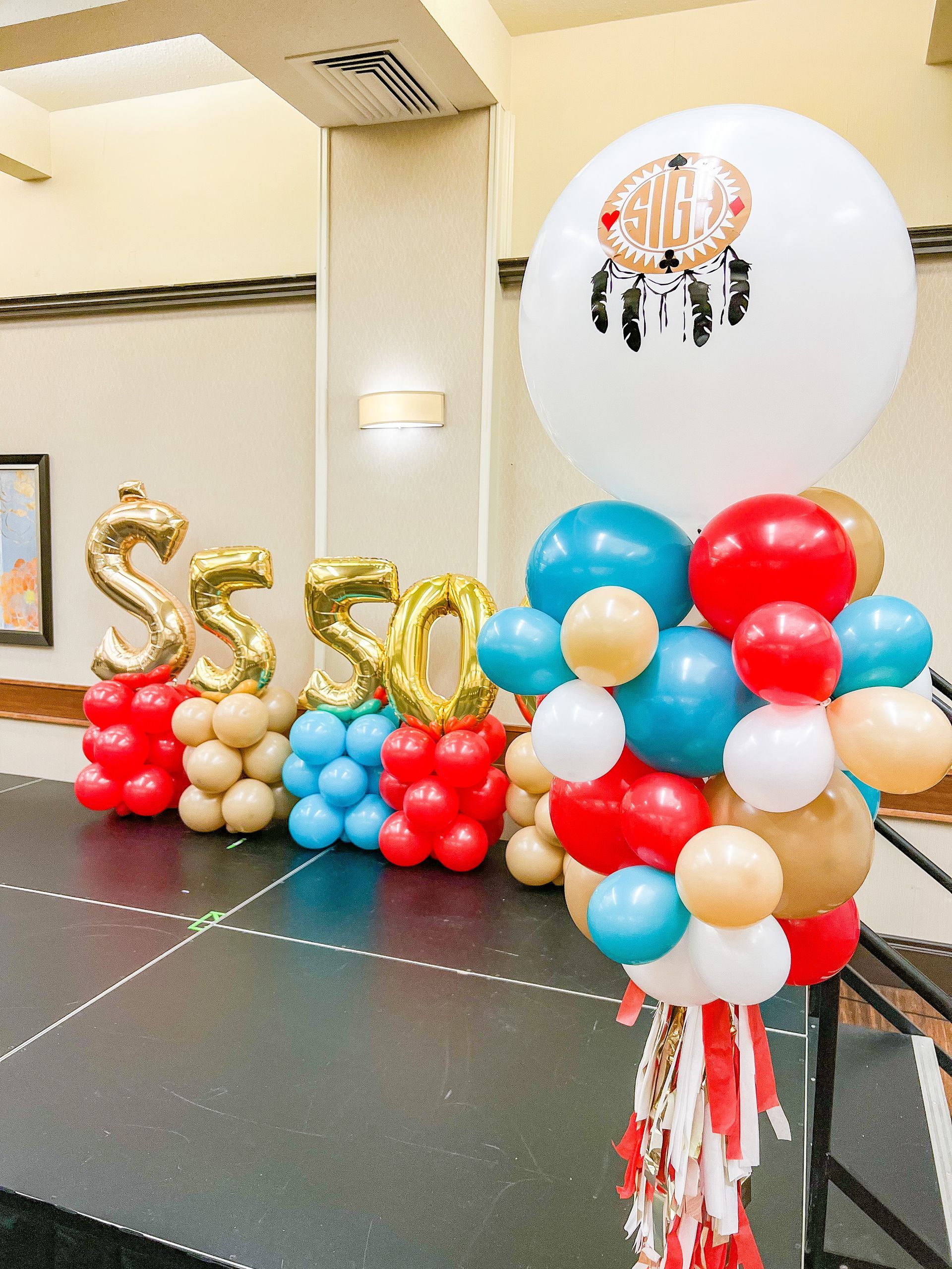 A bunch of balloons are stacked on top of each other on a stage.