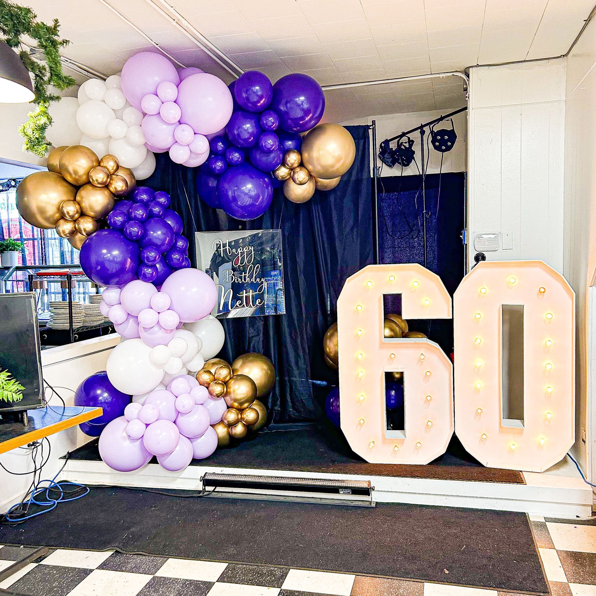 A room with balloons and a sign that says 60