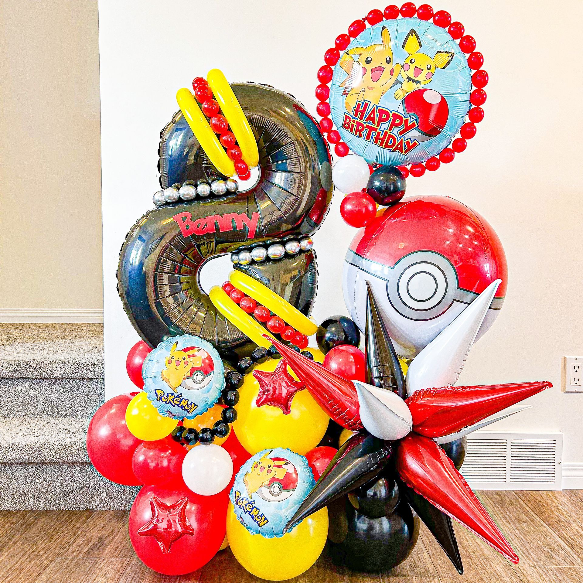 A bunch of balloons are sitting on a wooden floor.