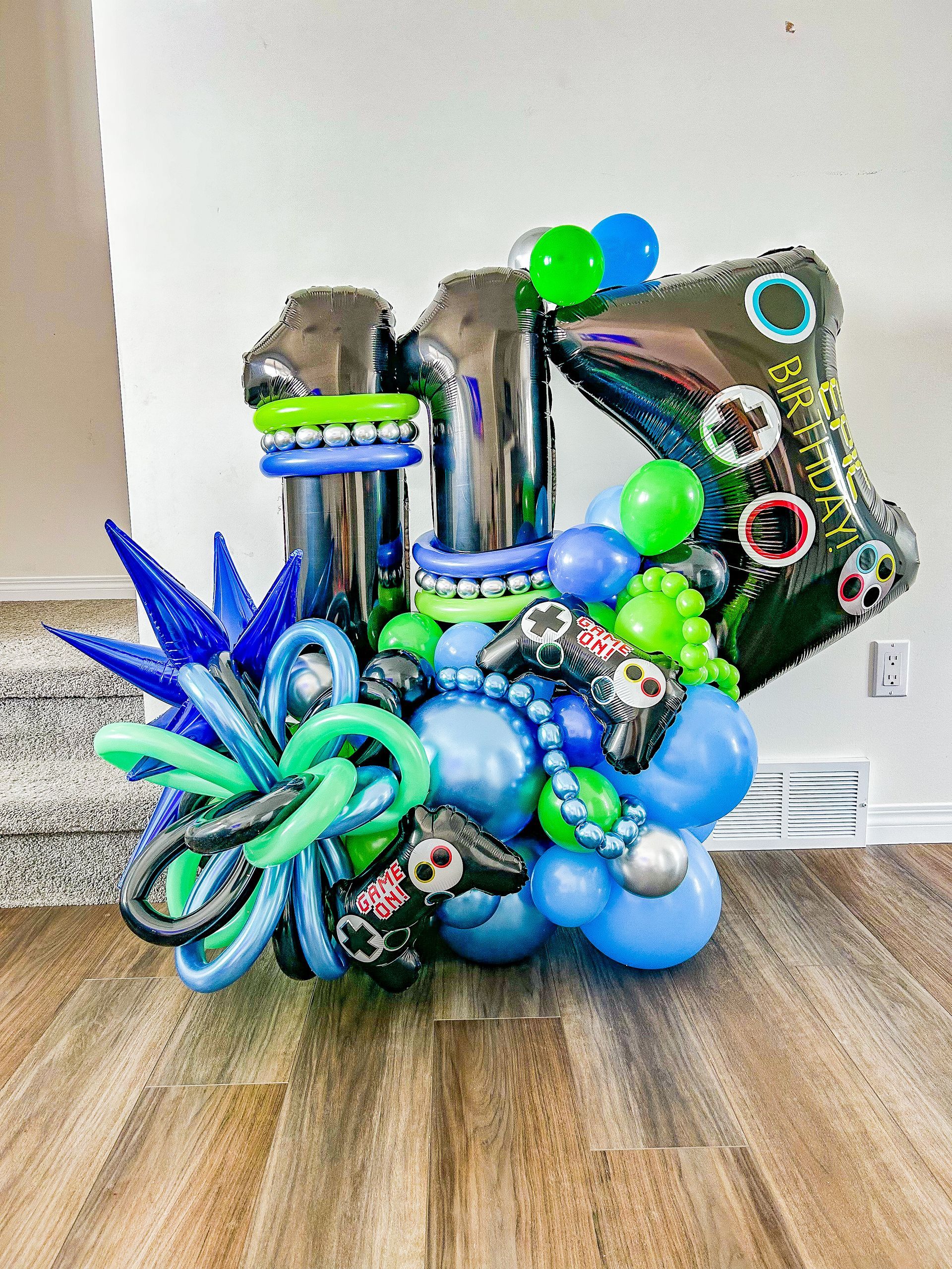 A bunch of balloons are sitting on a wooden floor.