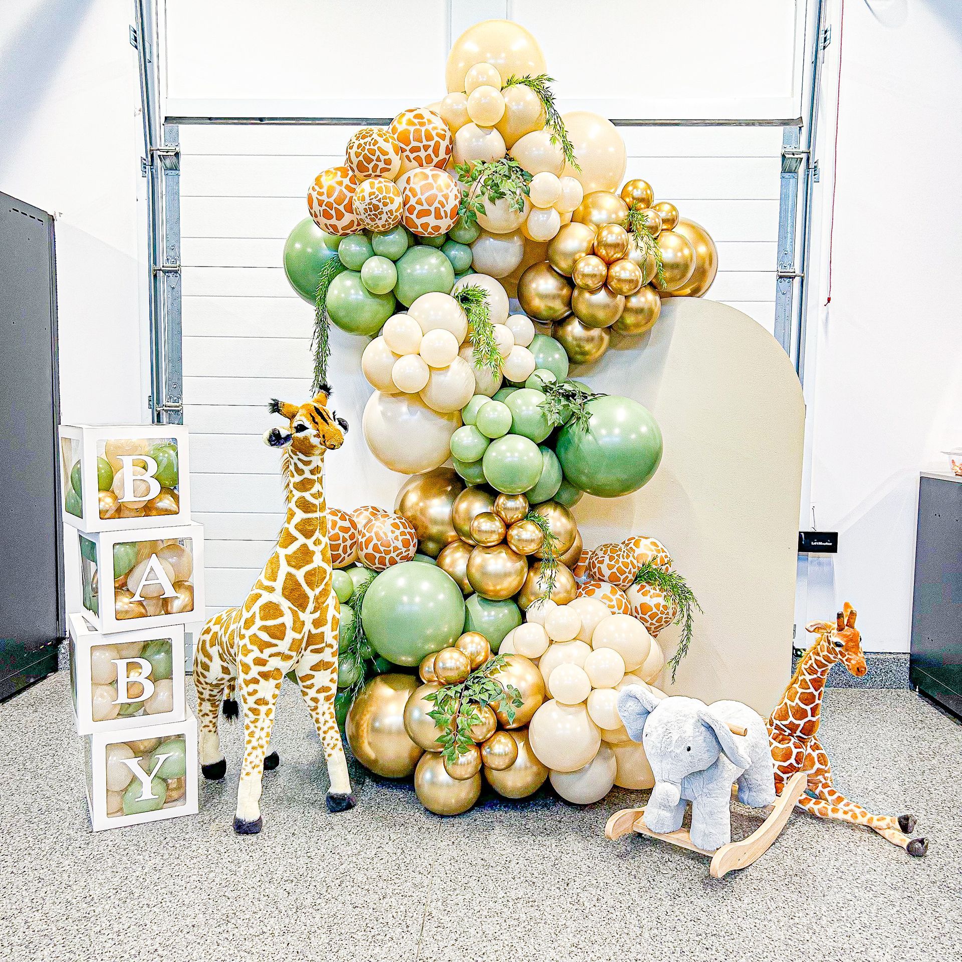 A bunch of balloons and stuffed animals are sitting on the floor.