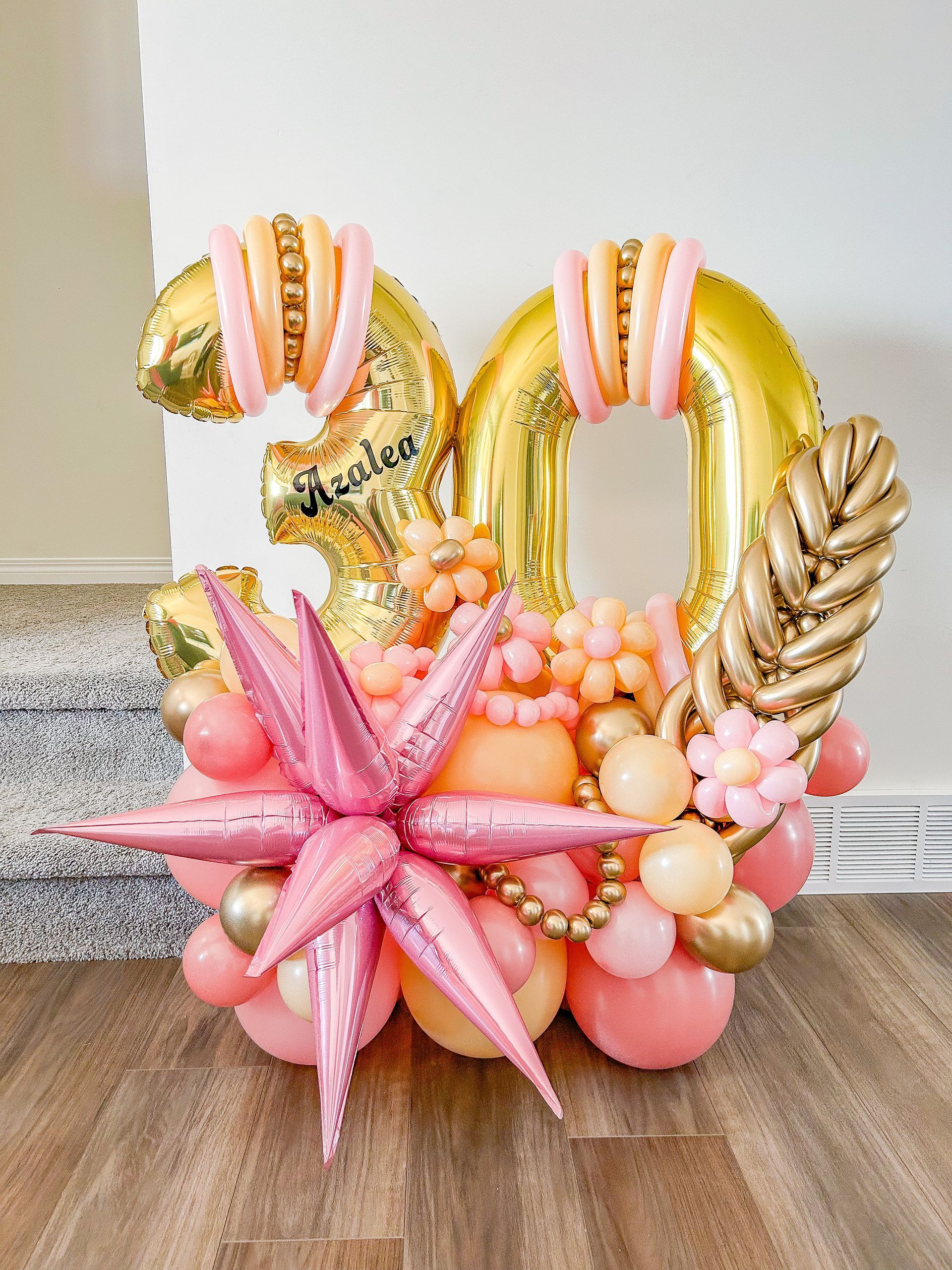 A bunch of balloons are sitting on a wooden floor.