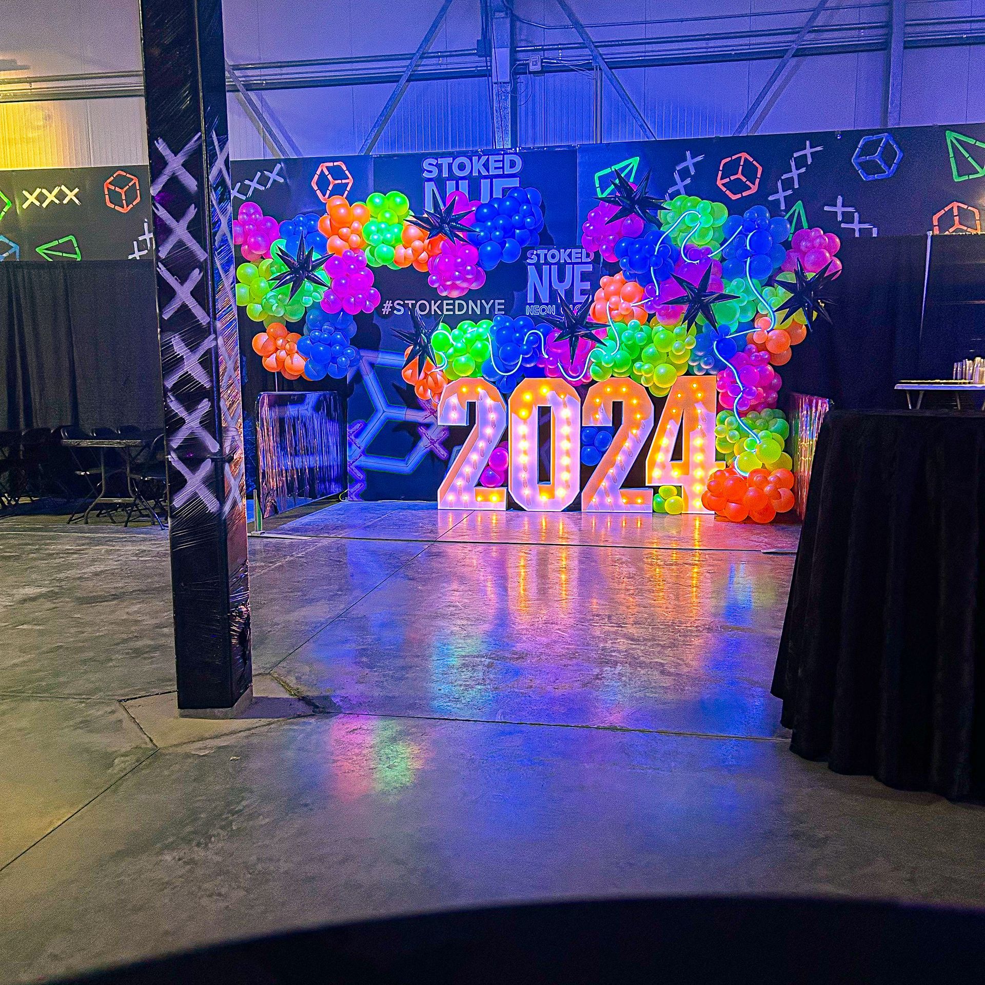 A room with balloons and a sign that says 2024