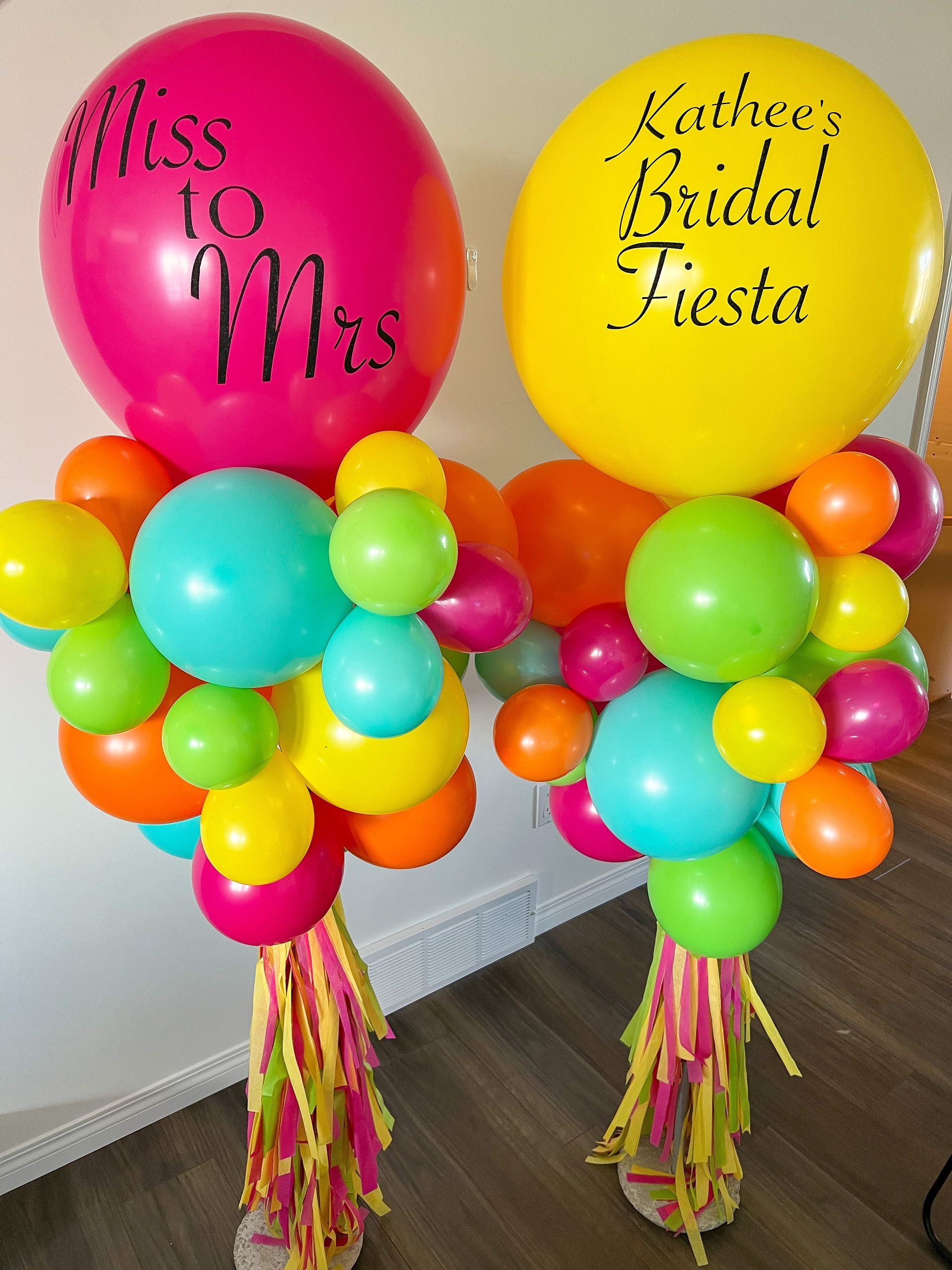 Two balloons with the words miss to mrs written on them