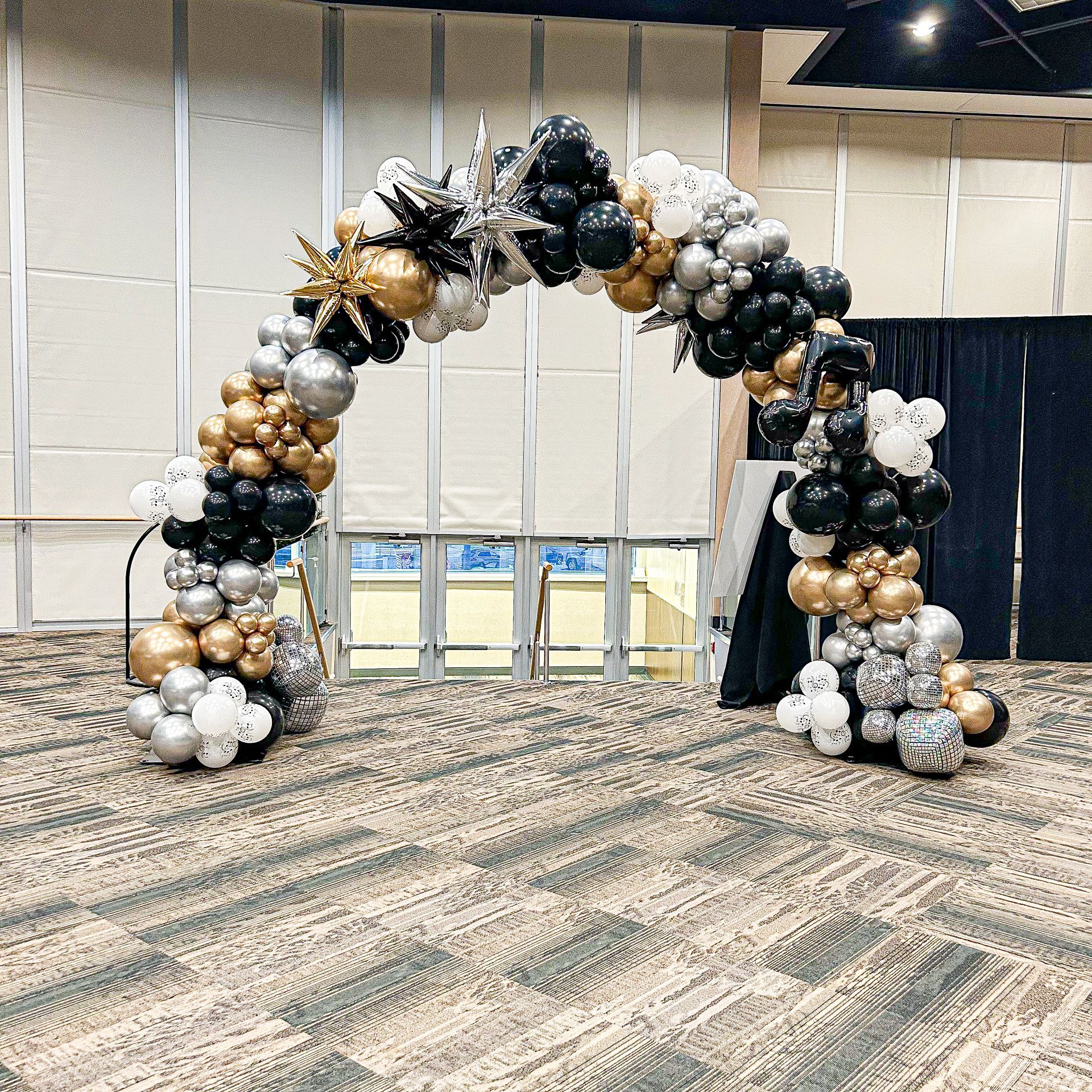 A large arch made of balloons in a room.
