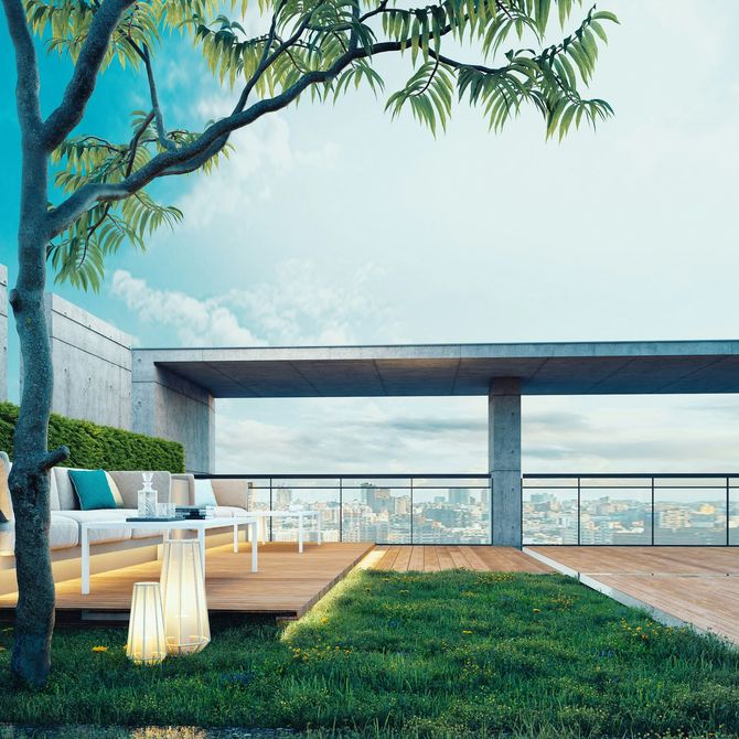Modern rooftop terrace with lounge chairs, grass, and a scenic city view under a blue sky