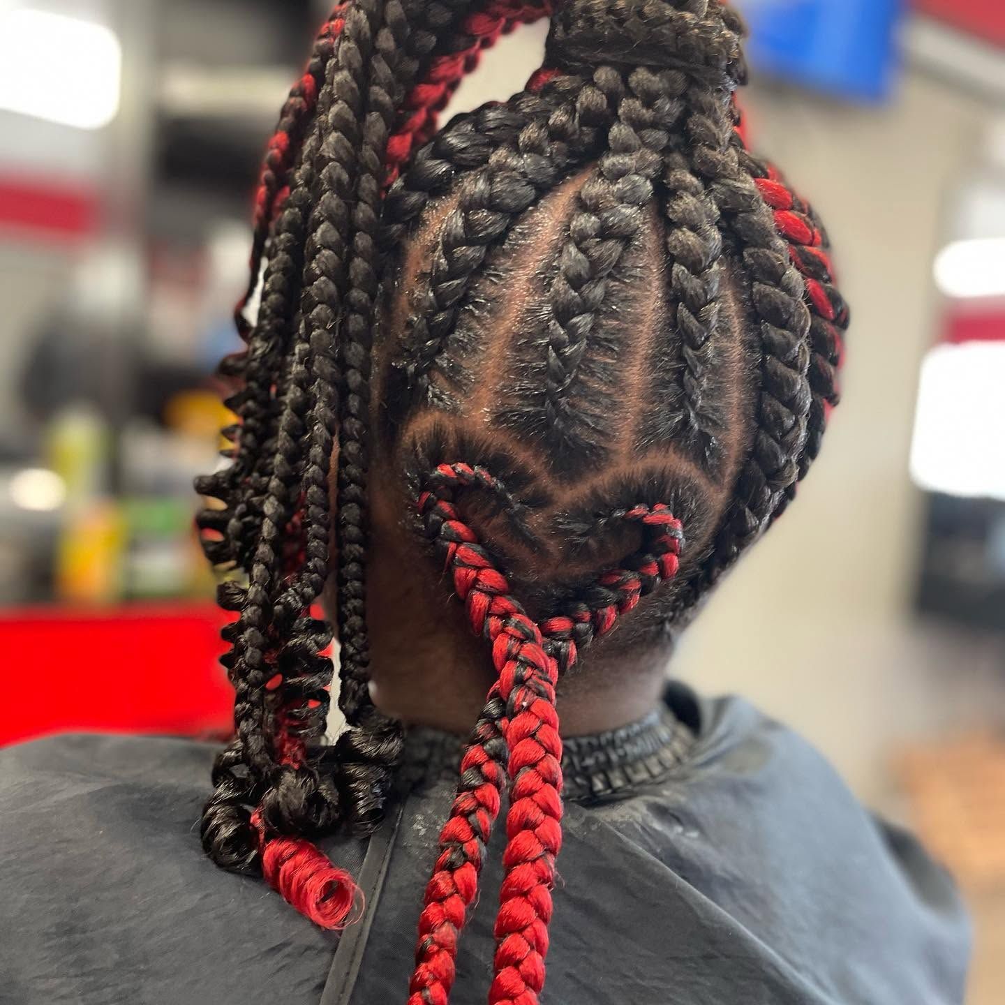 A woman with red and black braids in her hair