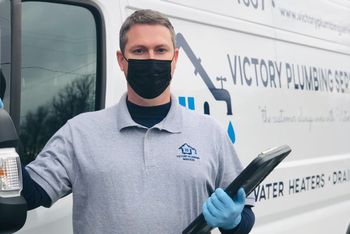 owner wearing mask in front of company truck