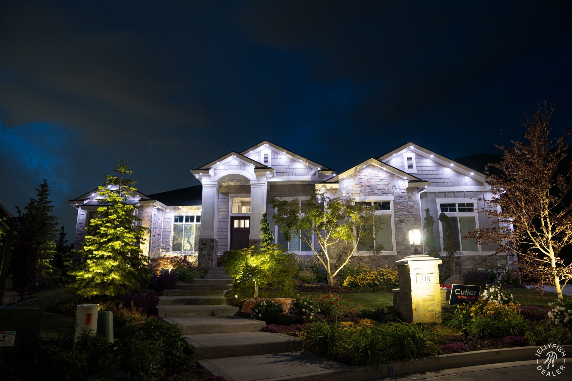 A large house is lit up at night with lots of lights.