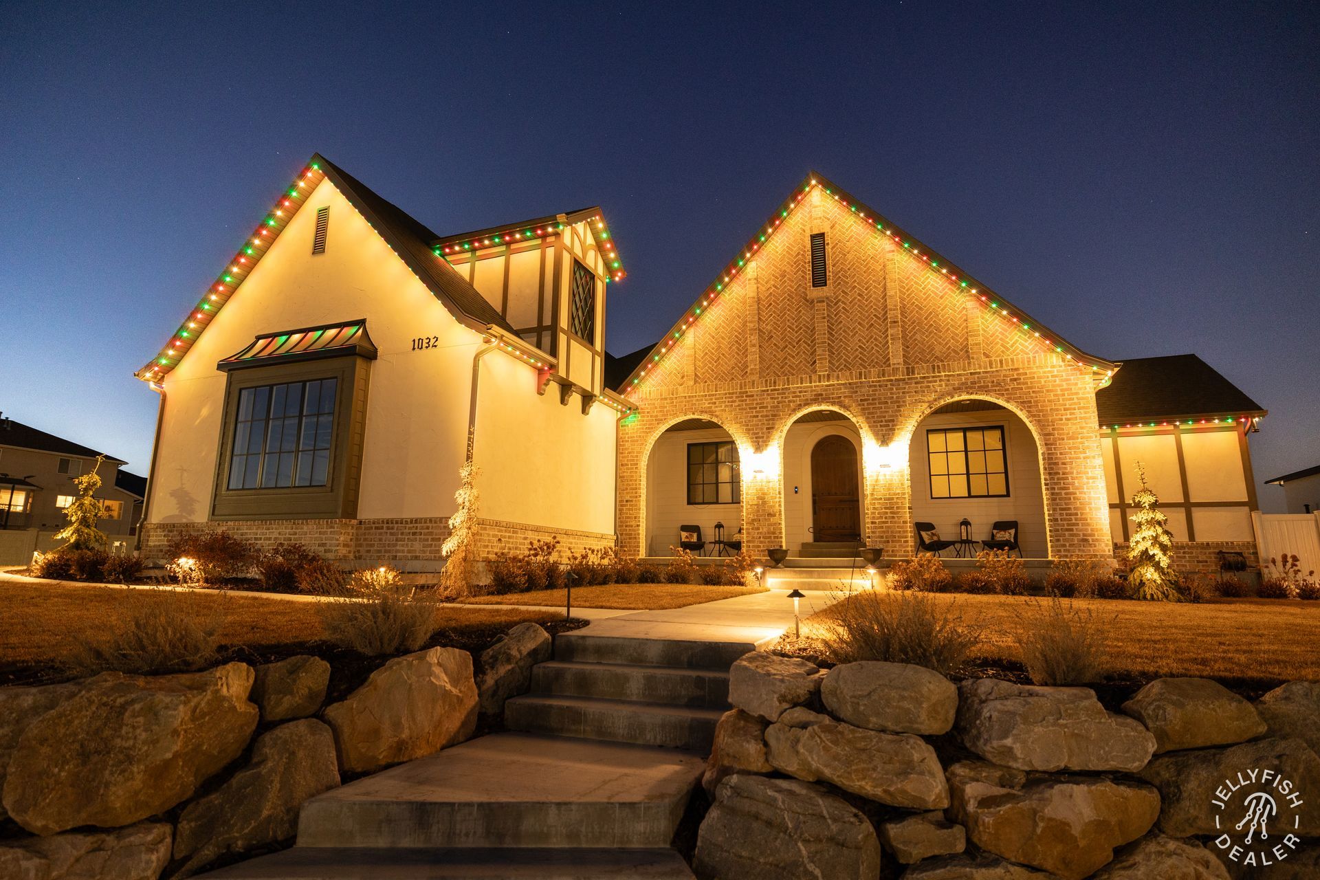 A house with christmas lights on it is lit up at night