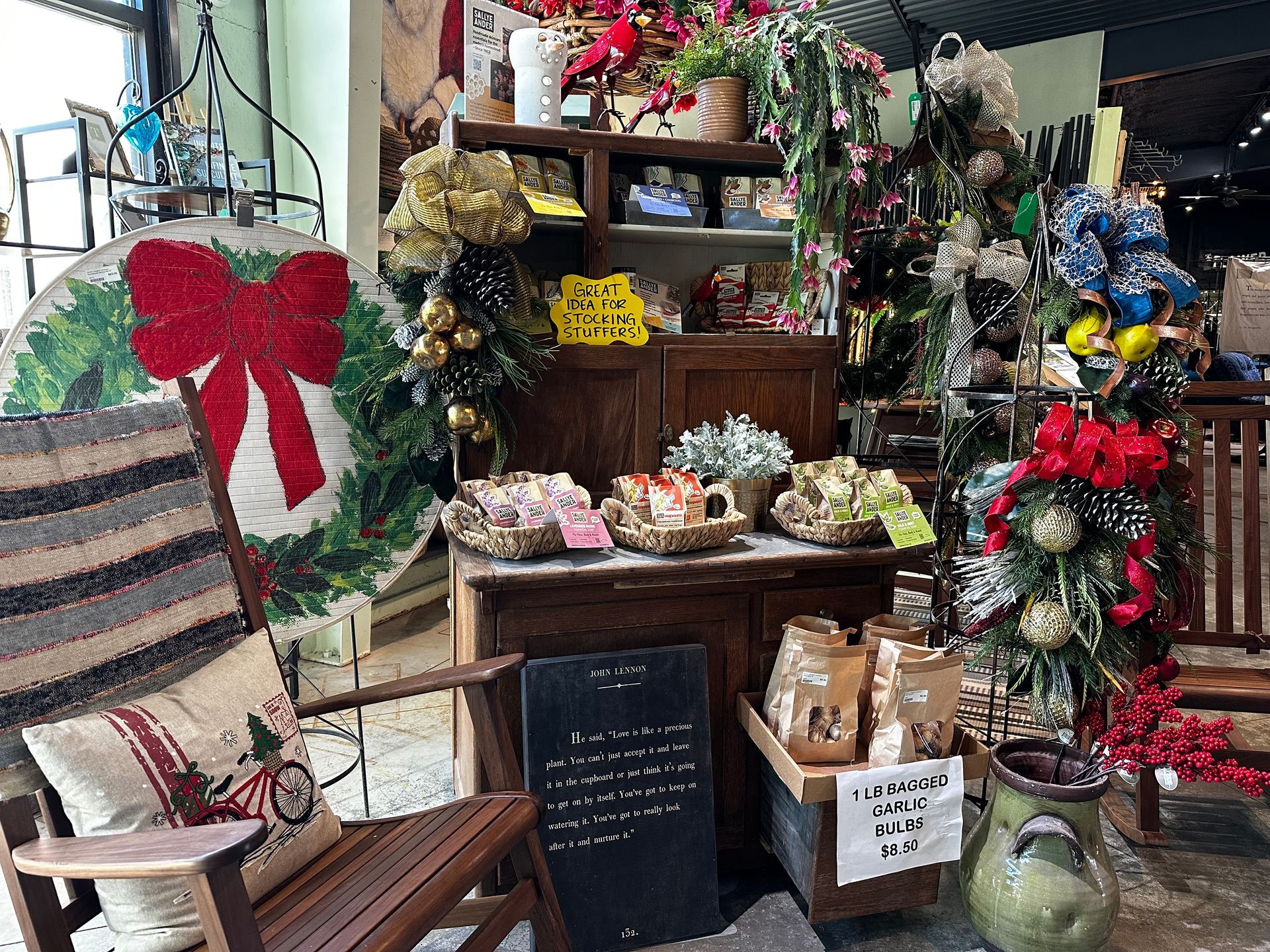 A wooden rocking chair with a red bow on it is in a room with christmas decorations.