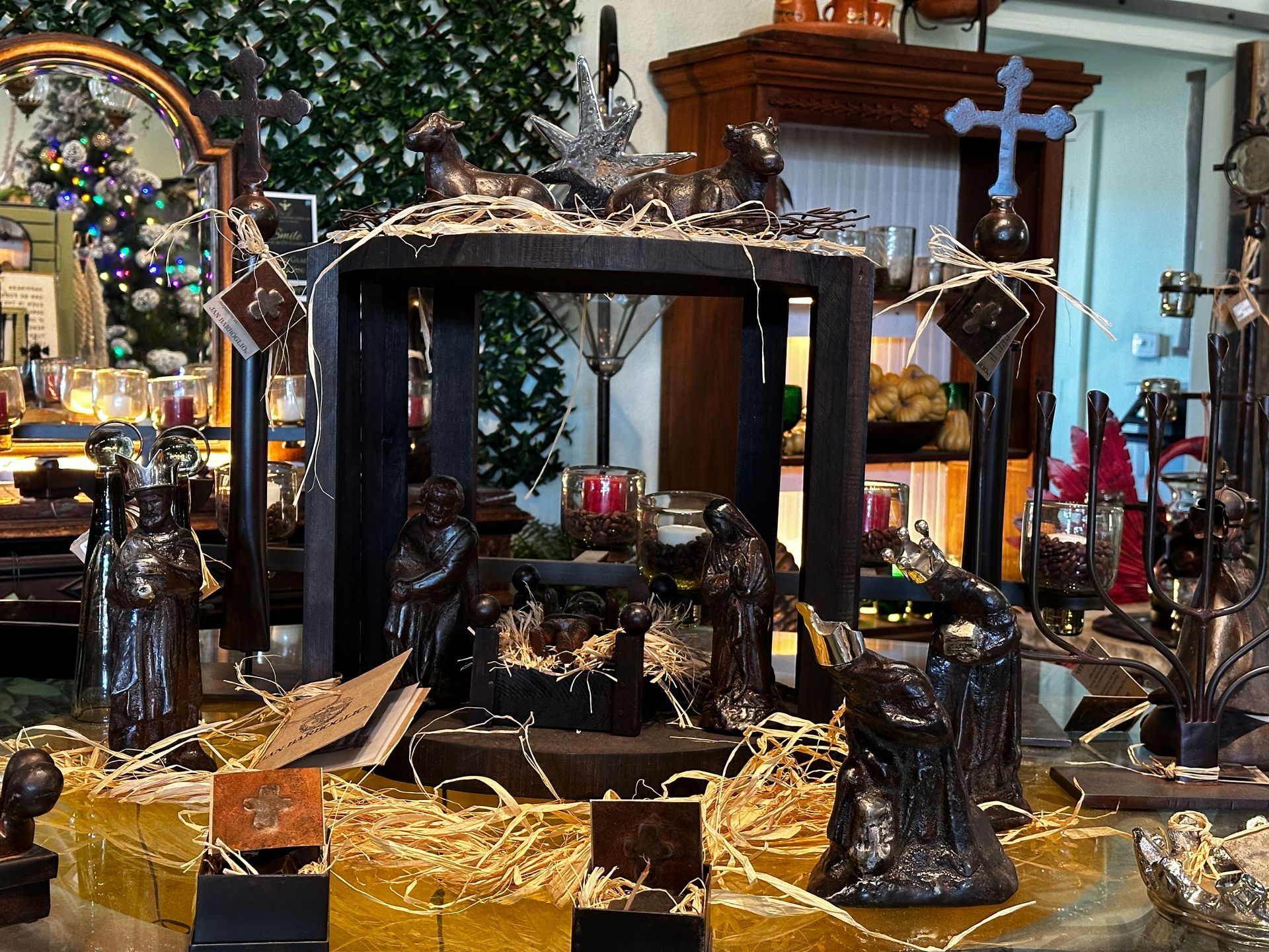 A nativity scene is displayed on a table in a store
