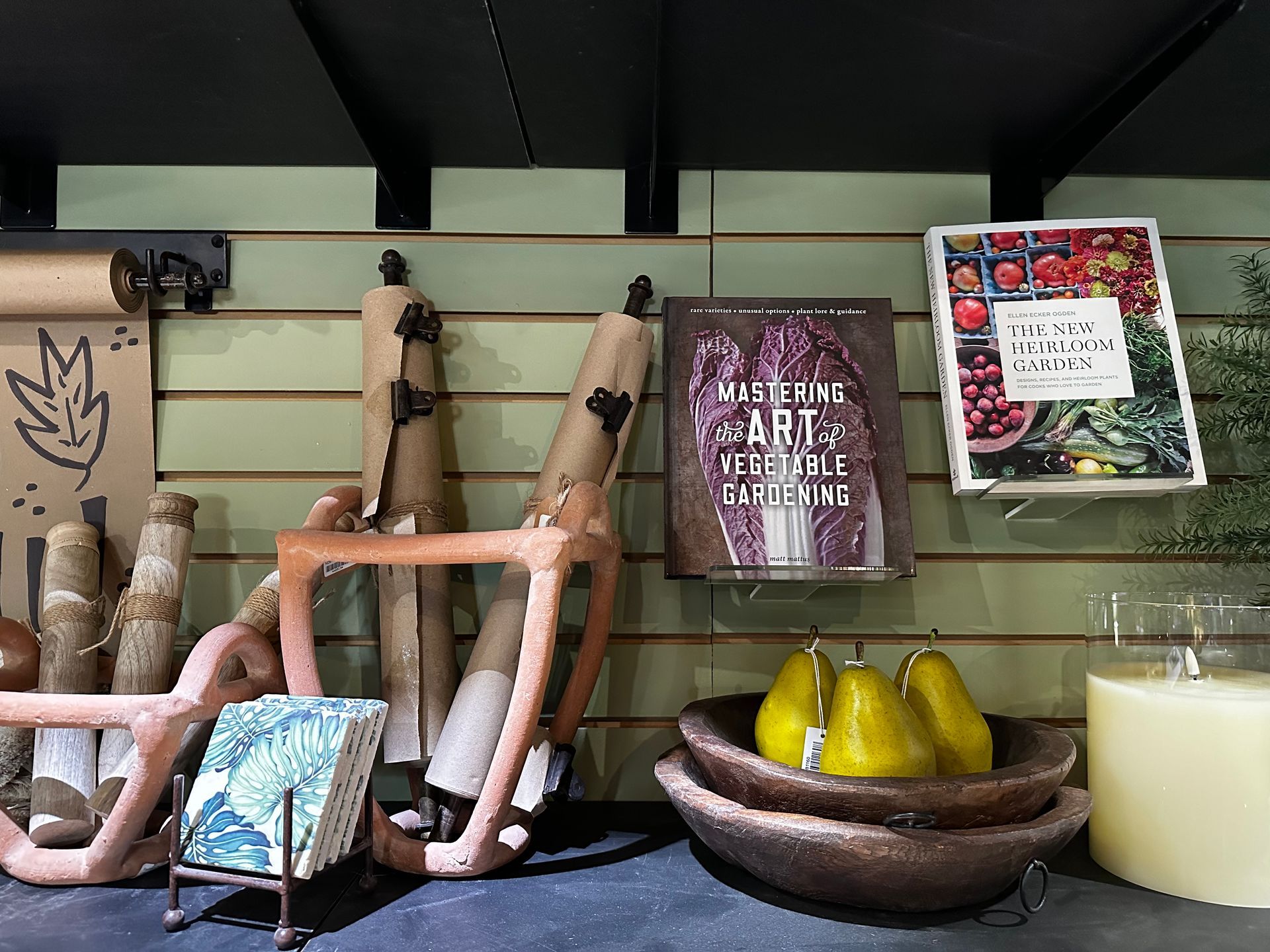 A table with a bowl of pears and a book on it.