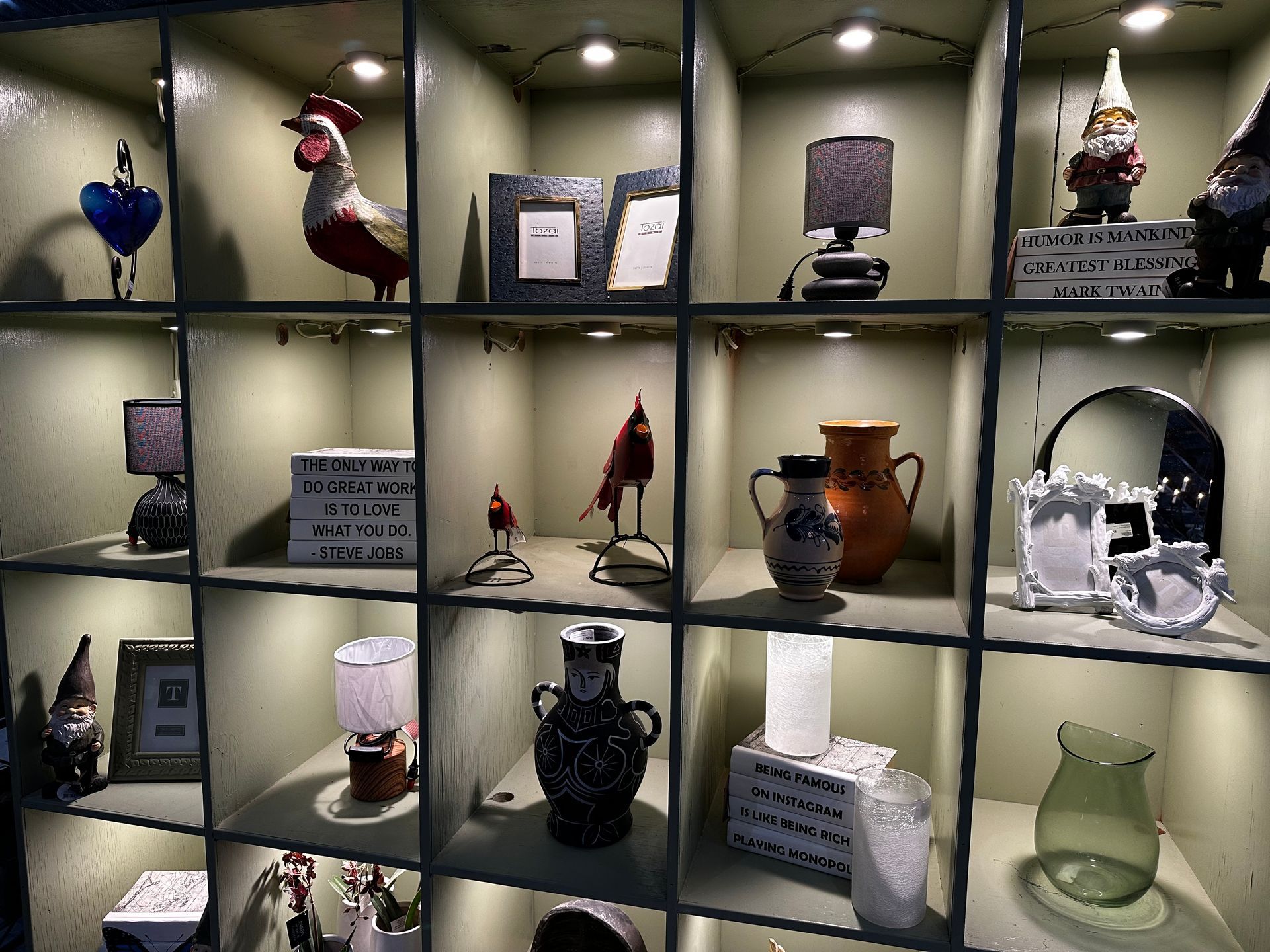 A shelf filled with lots of vases and figurines
