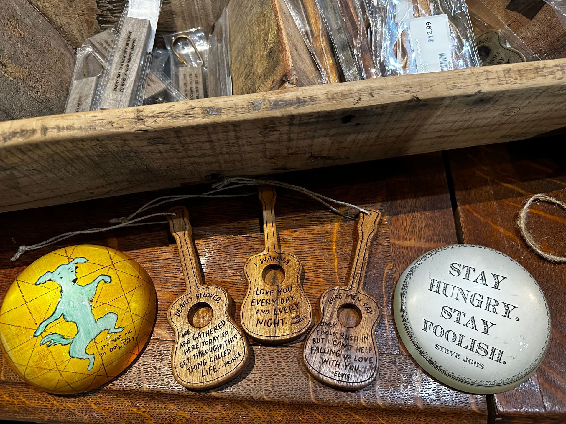 A wooden table with a tray of utensils and a sign that says 